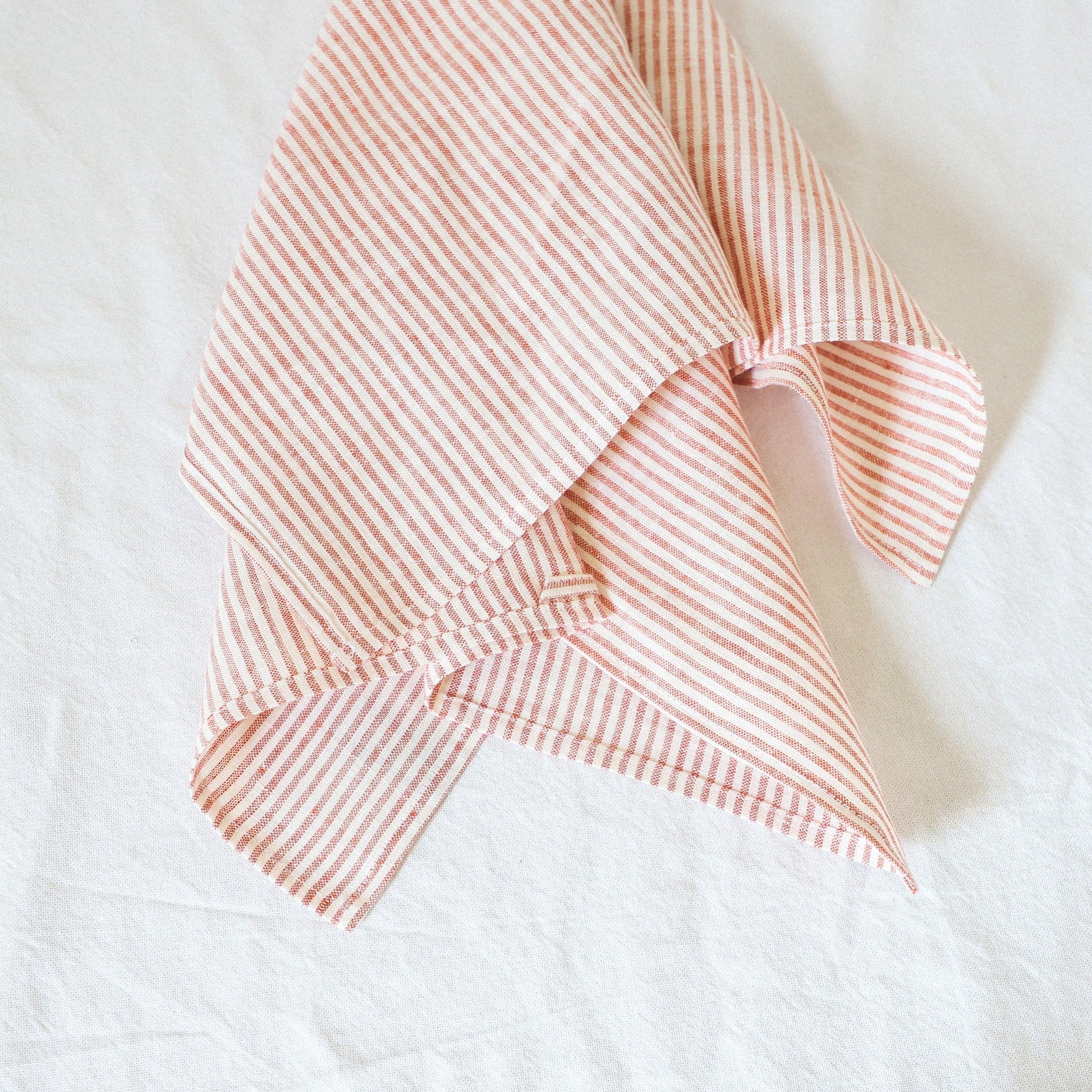 The Grace & Company Linen Way Red Picnic Kitchen Cloth is laid out on a white surface.