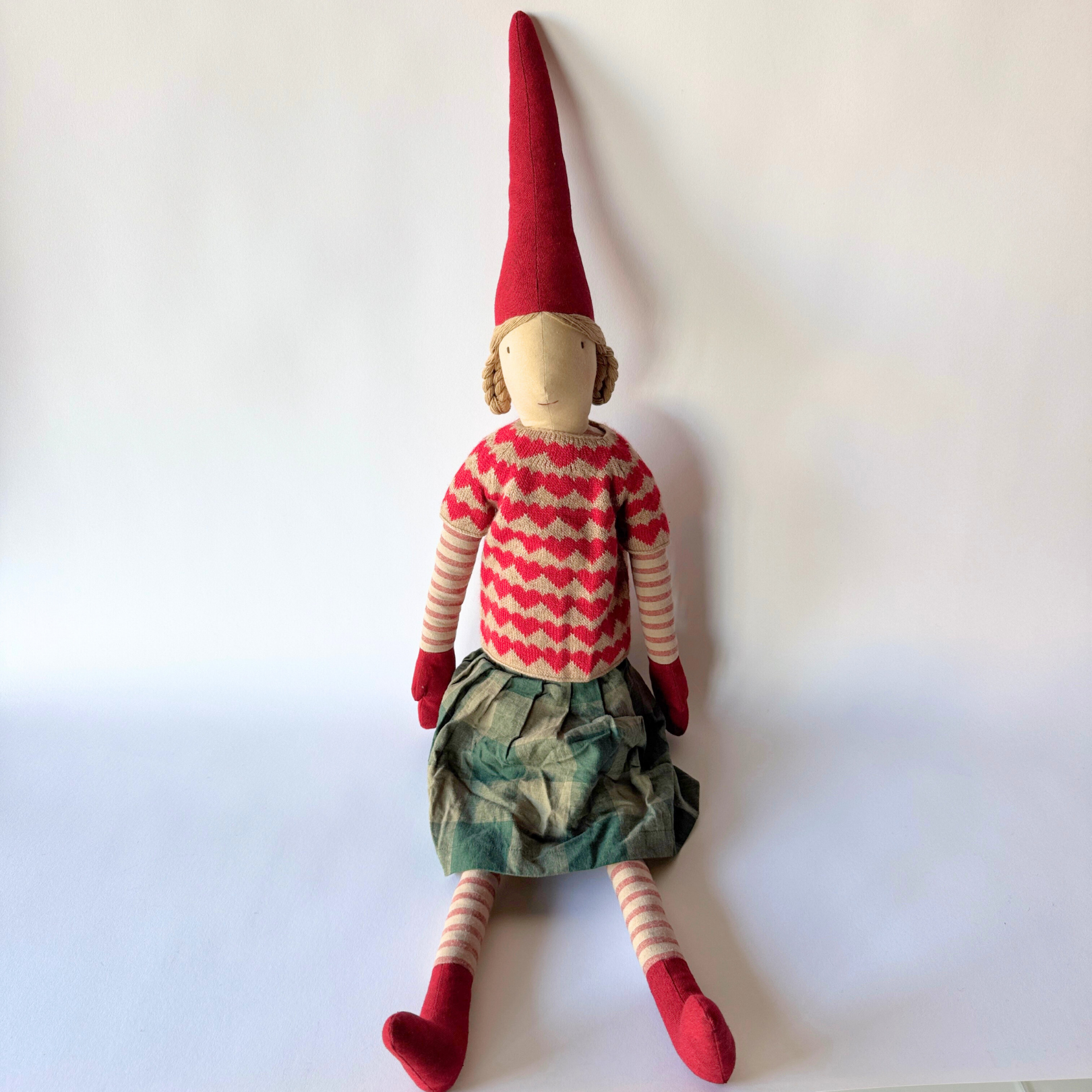 The Maileg - Christmas Pixy by Grace & Company sits in festive attire against a white background.