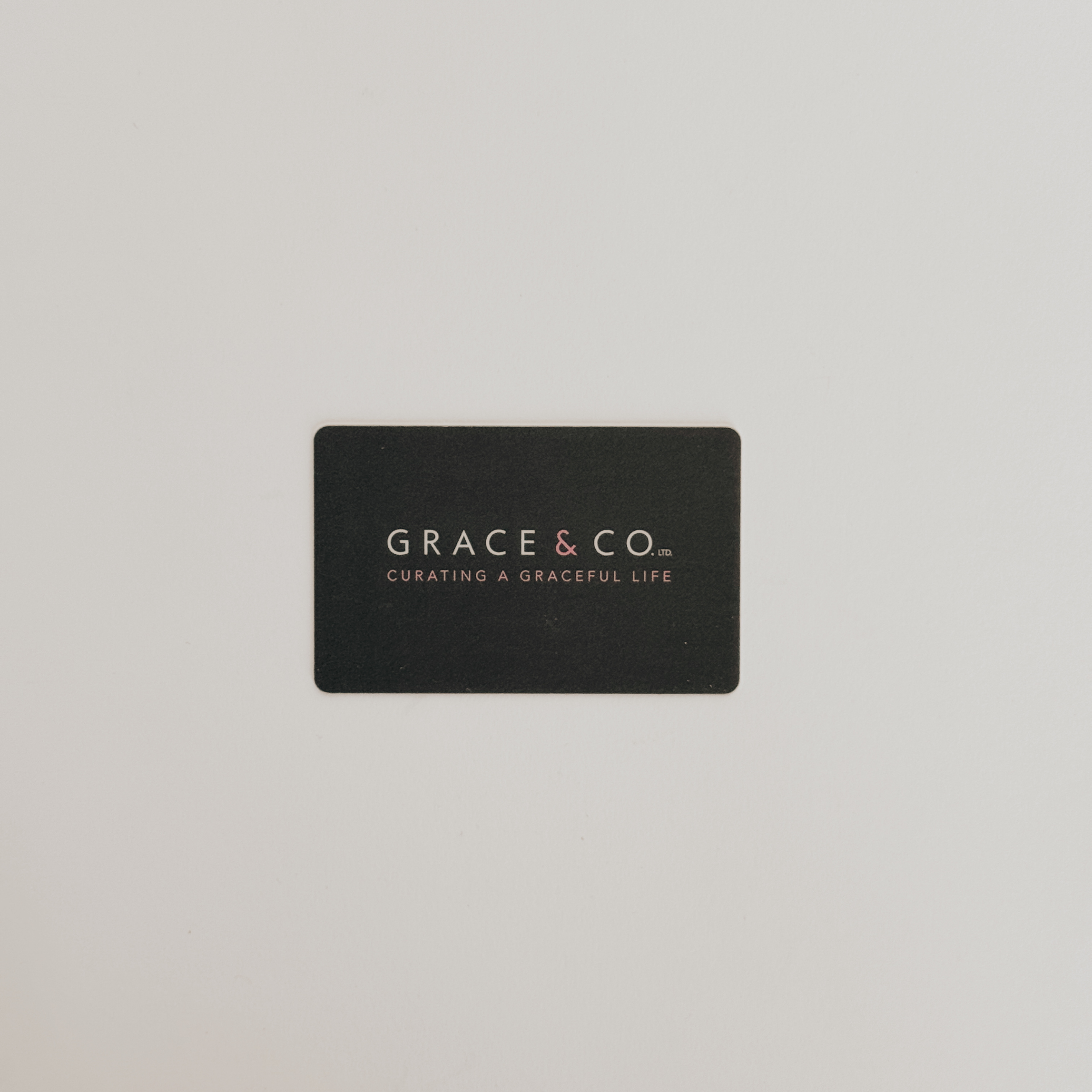 A Grace & Company Gift Card with Curating a Graceful Life on black, displayed against a white background.