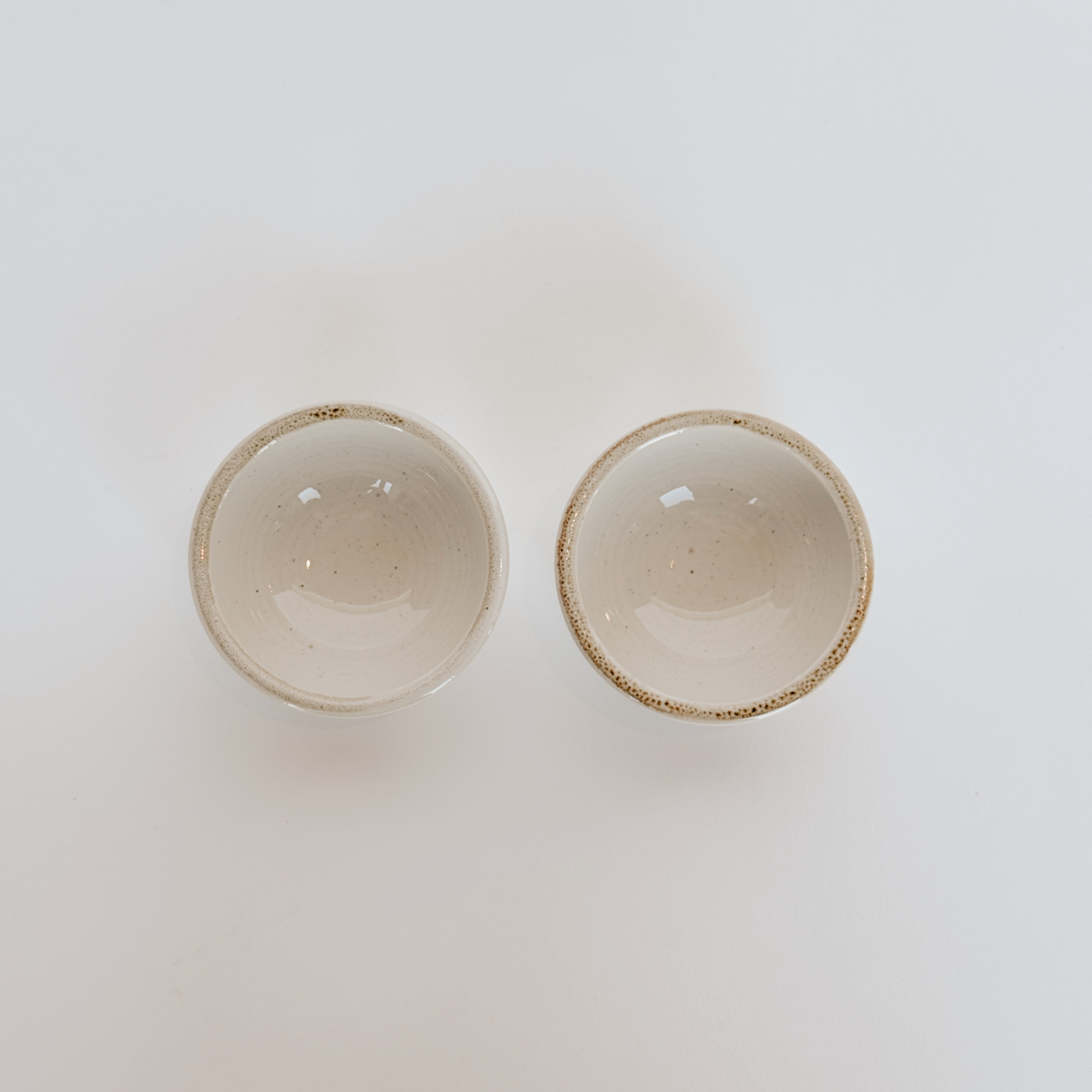 Two Casafina Sardegna White Ramekins by Grace & Company, side by side on a white background.