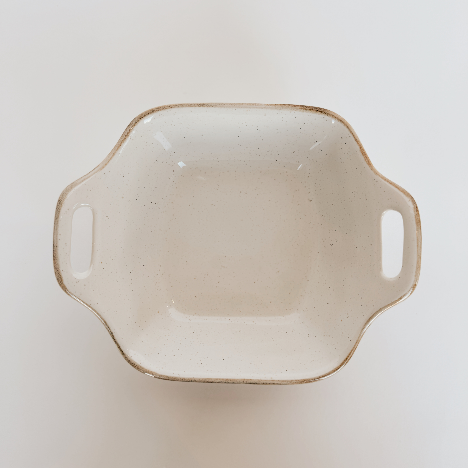 The Casafina - Sardegna Square Baker by Grace and Company Ltd, beige with side handles, shown from above on white.