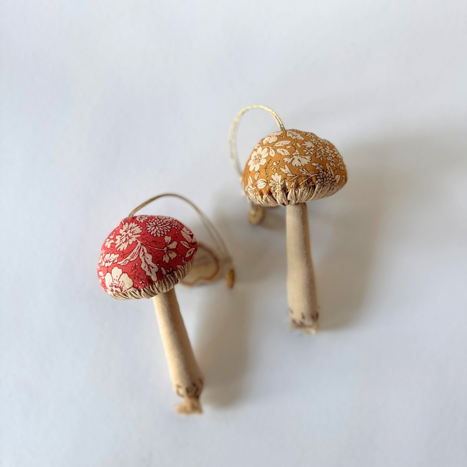 Maileg - Mushroom Ornament by Grace & Company: two fabric mushrooms, red and yellow caps, on white background.