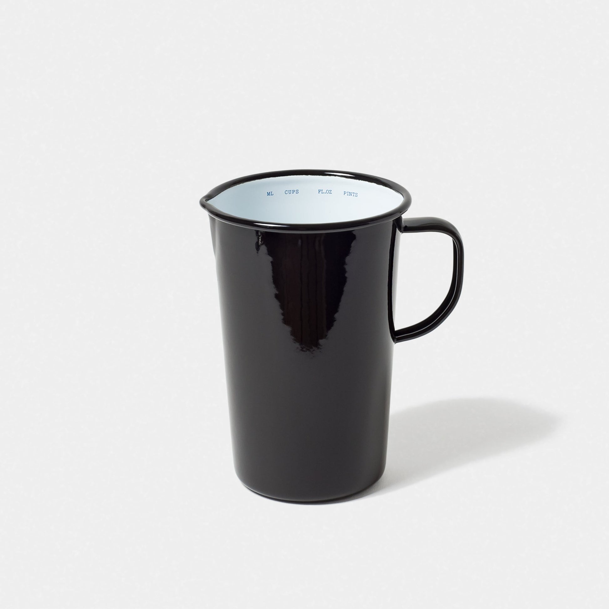 The Falcon Enamelware 2 Pint Jug by Grace & Company ltd, in black with handle, shown on a white background.