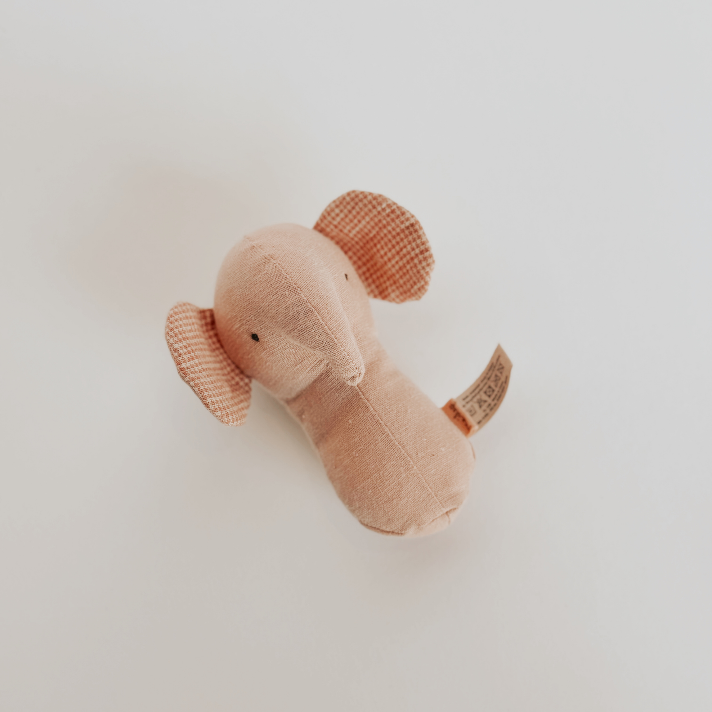 Grace & Company Maileg Lullaby Friends Elephant Rattle Rose, a small plush toy with checkered ears, soft and pink.