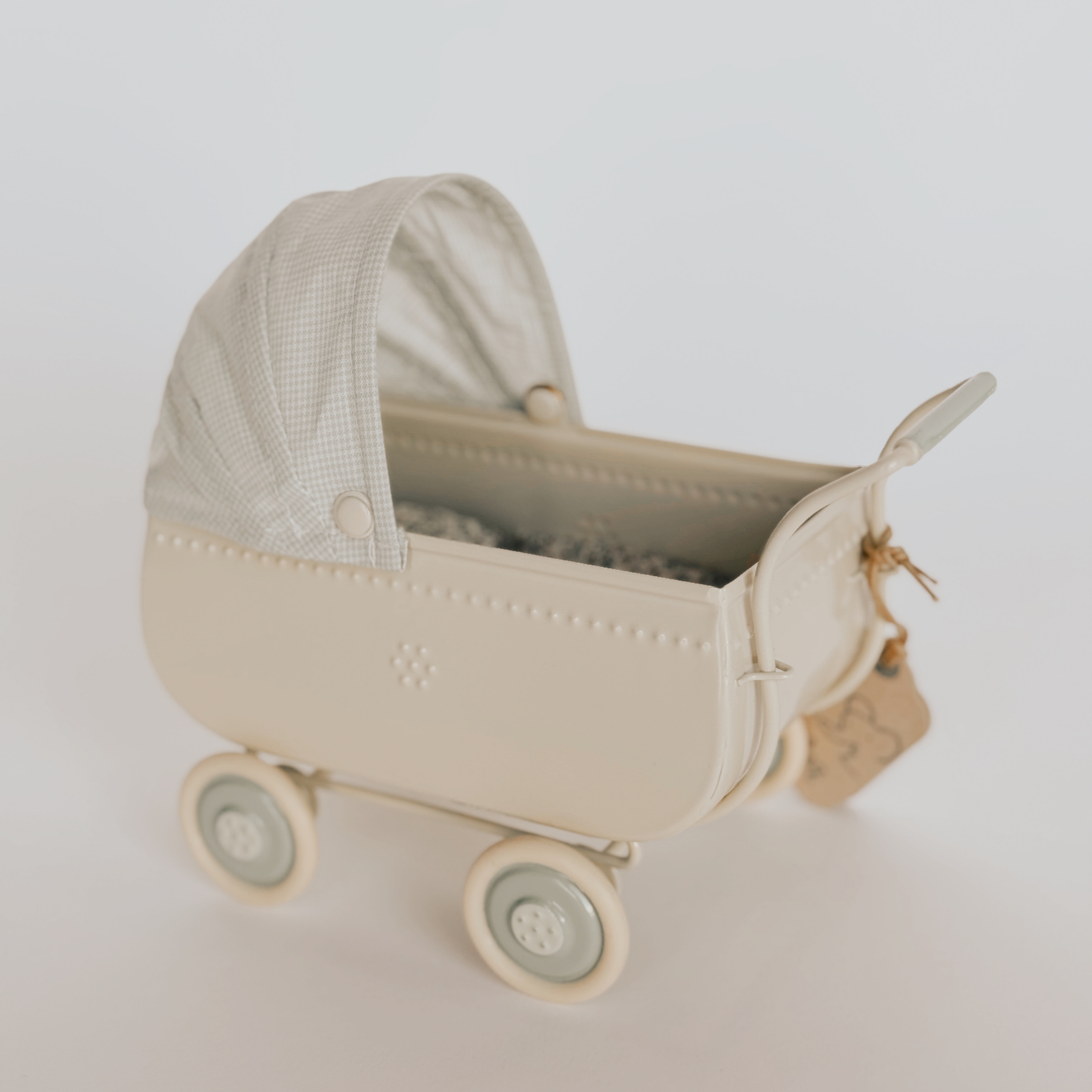 The Grace & Company ltd Maileg Blue Pram is a small, vintage-style stroller with a blue body and four round wheels.