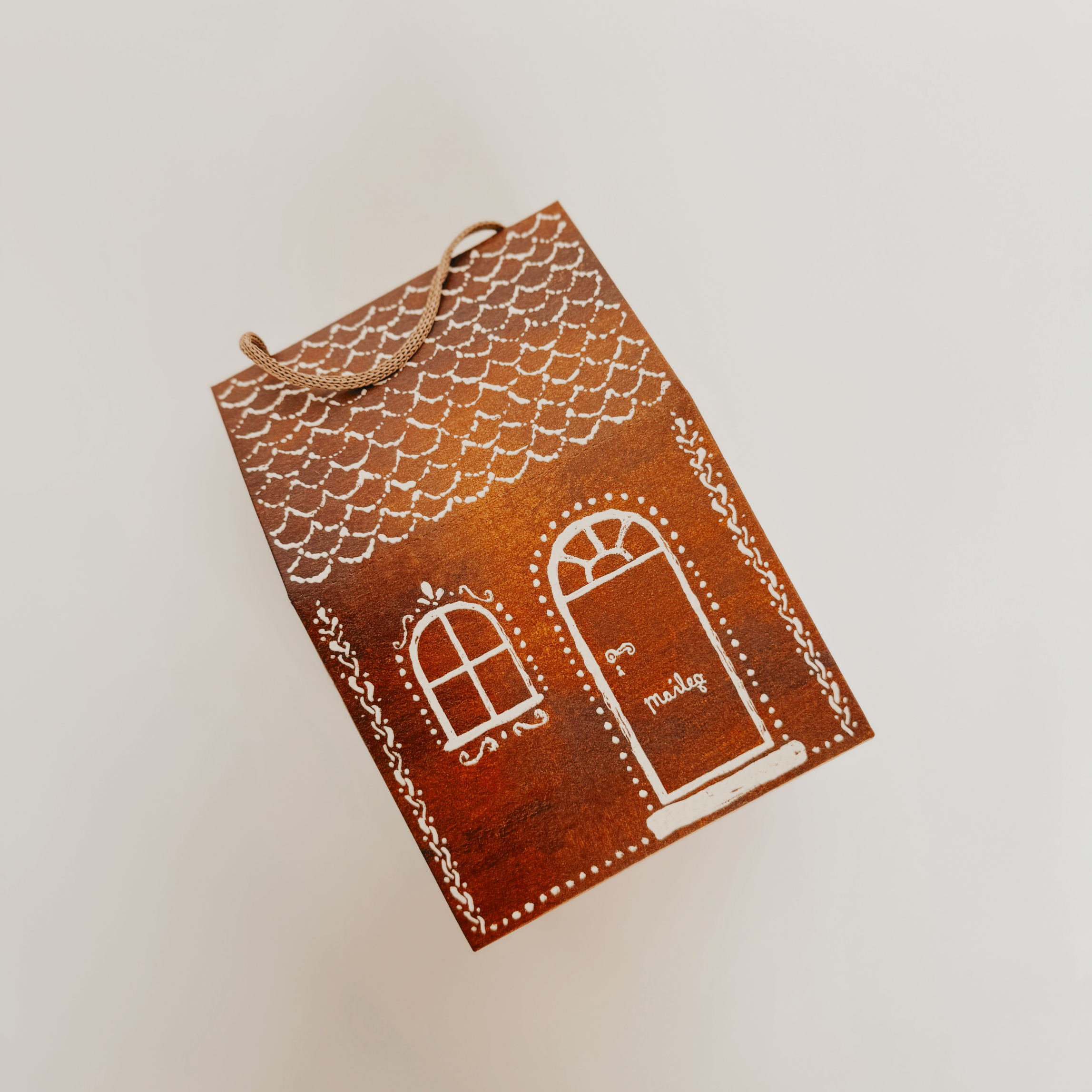 Maileg - Assorted Gift Wrap by Grace & Company: A small brown house-shaped box with white window and door designs.