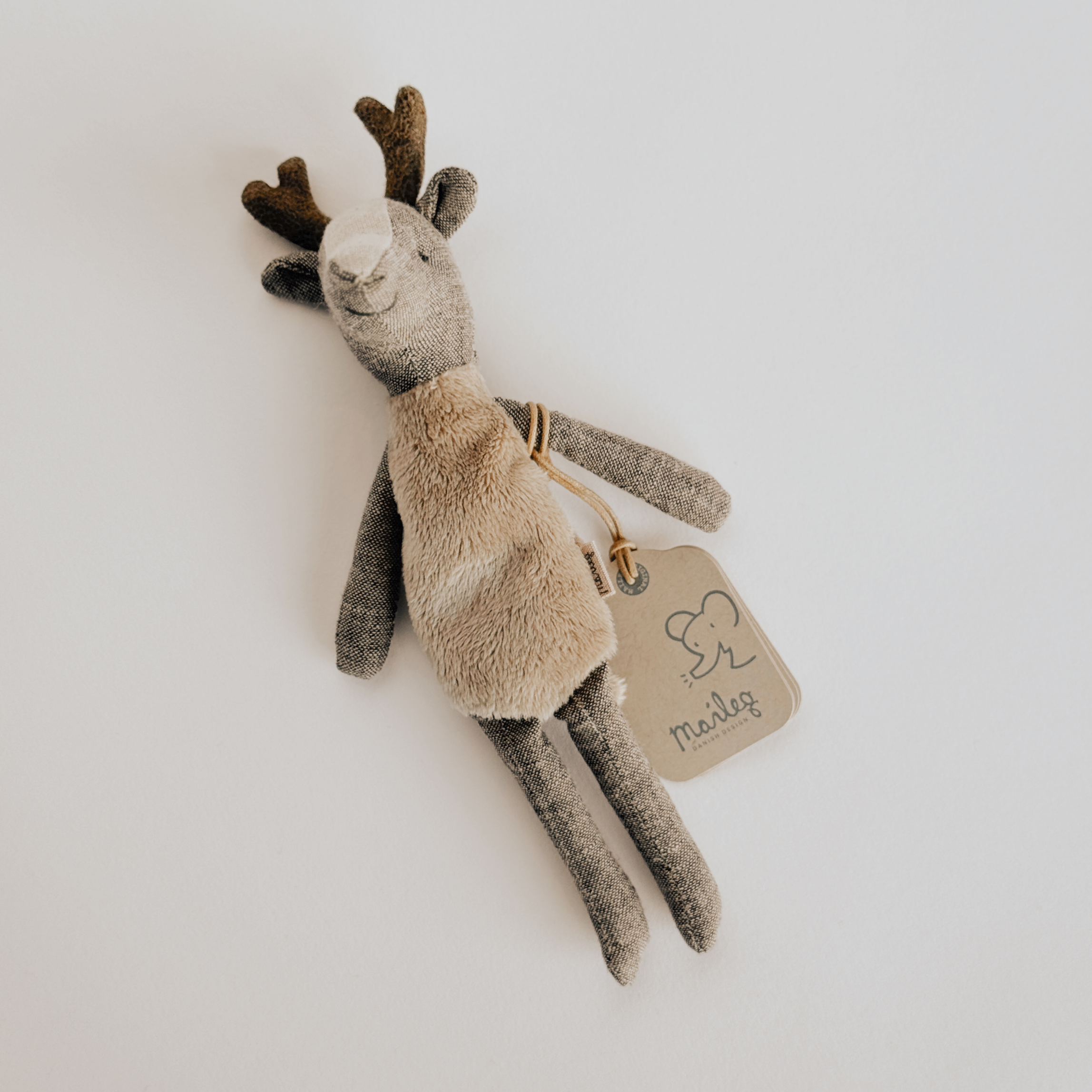 Maileg - Deer Father by Grace & Company, plush reindeer toy with beige tag and elephant illustration on white background.