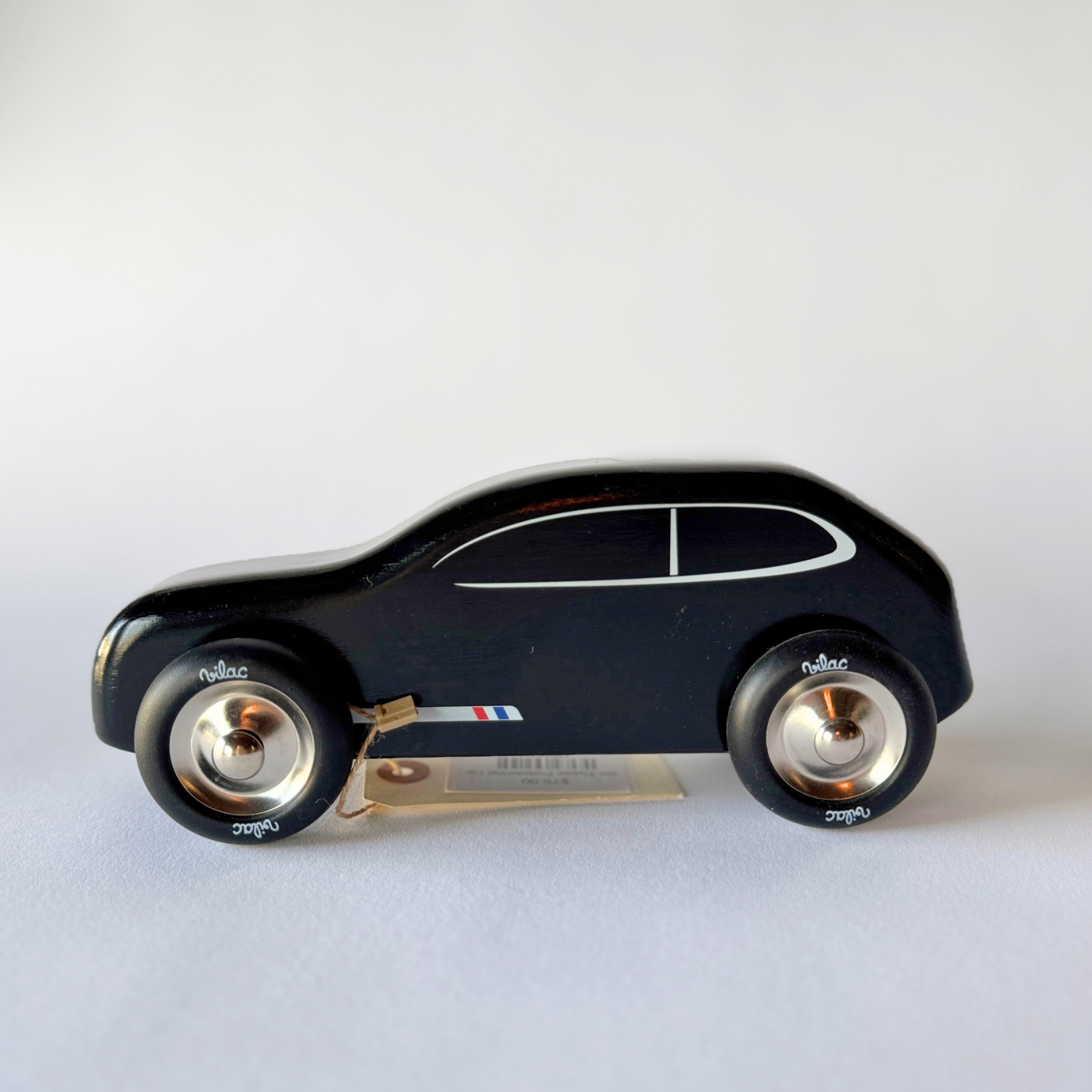 Grace & Company Vilac - Elysee Presidential Car: black wood toy with silver wheels and window, shown on white surface.