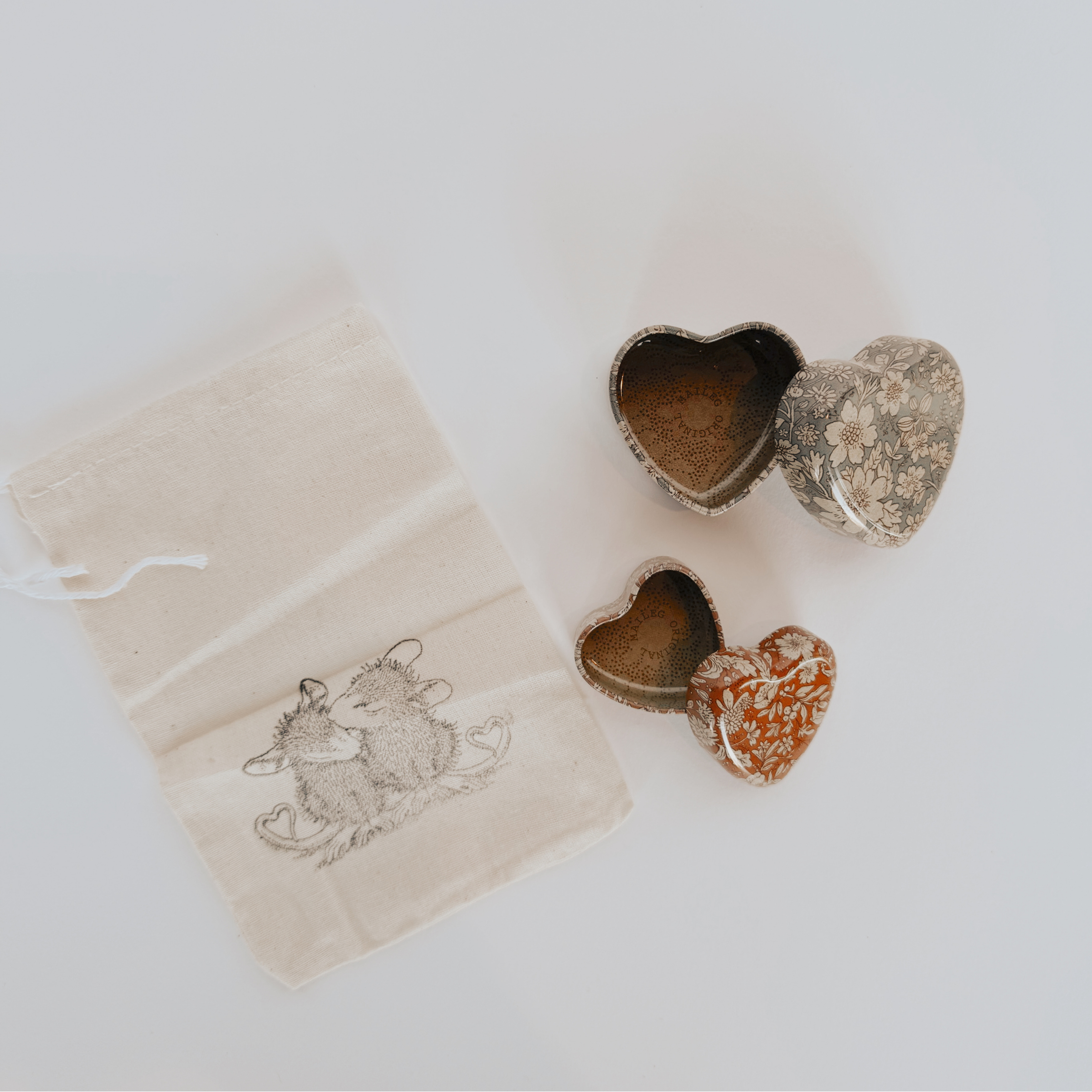 Two Grace & Company Maileg Metal Heart Boxes and a pouch with two mice, all on a white background.