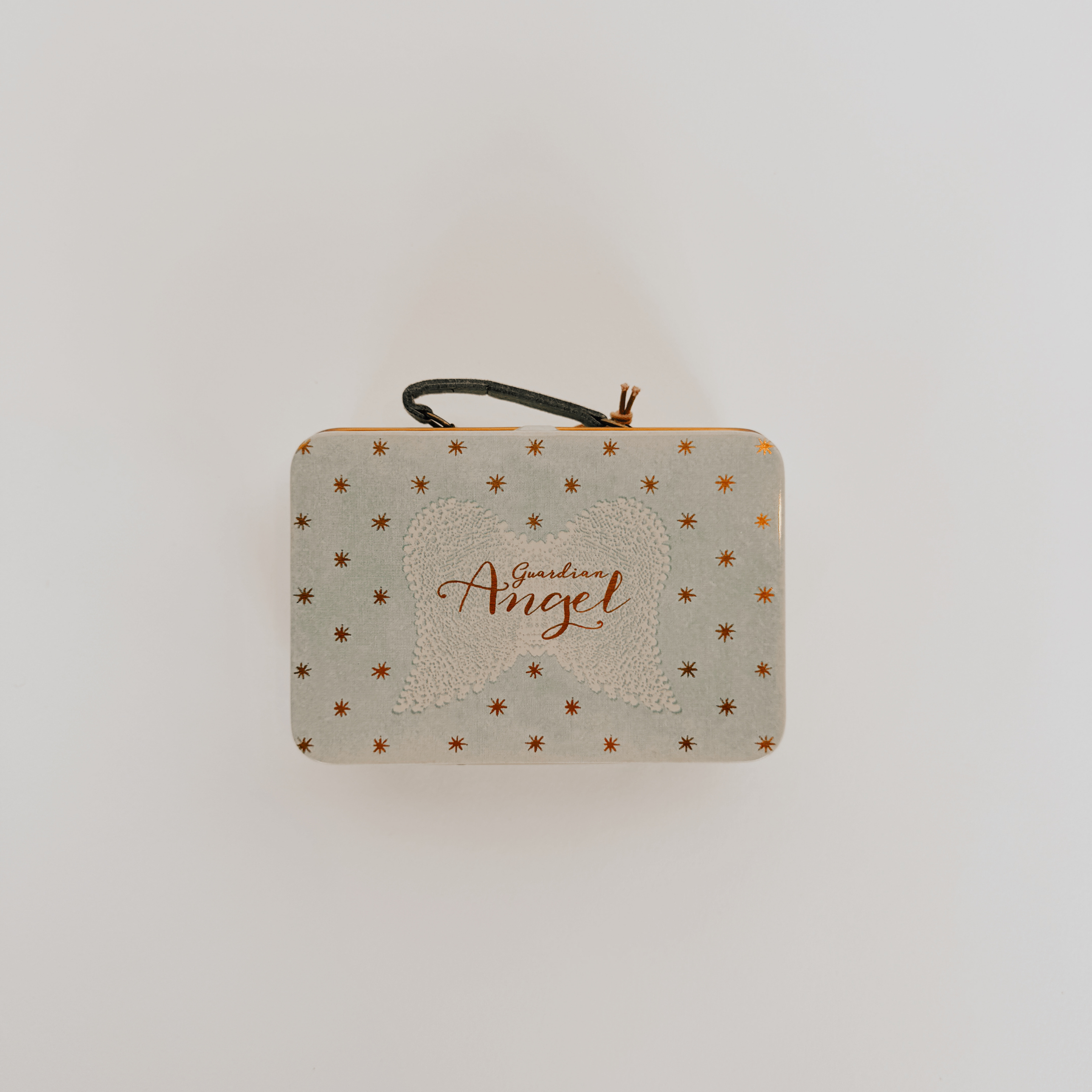 The Maileg Small Blue Suitcase by Grace & Company features star patterns, a black handle, and an angel wing design.