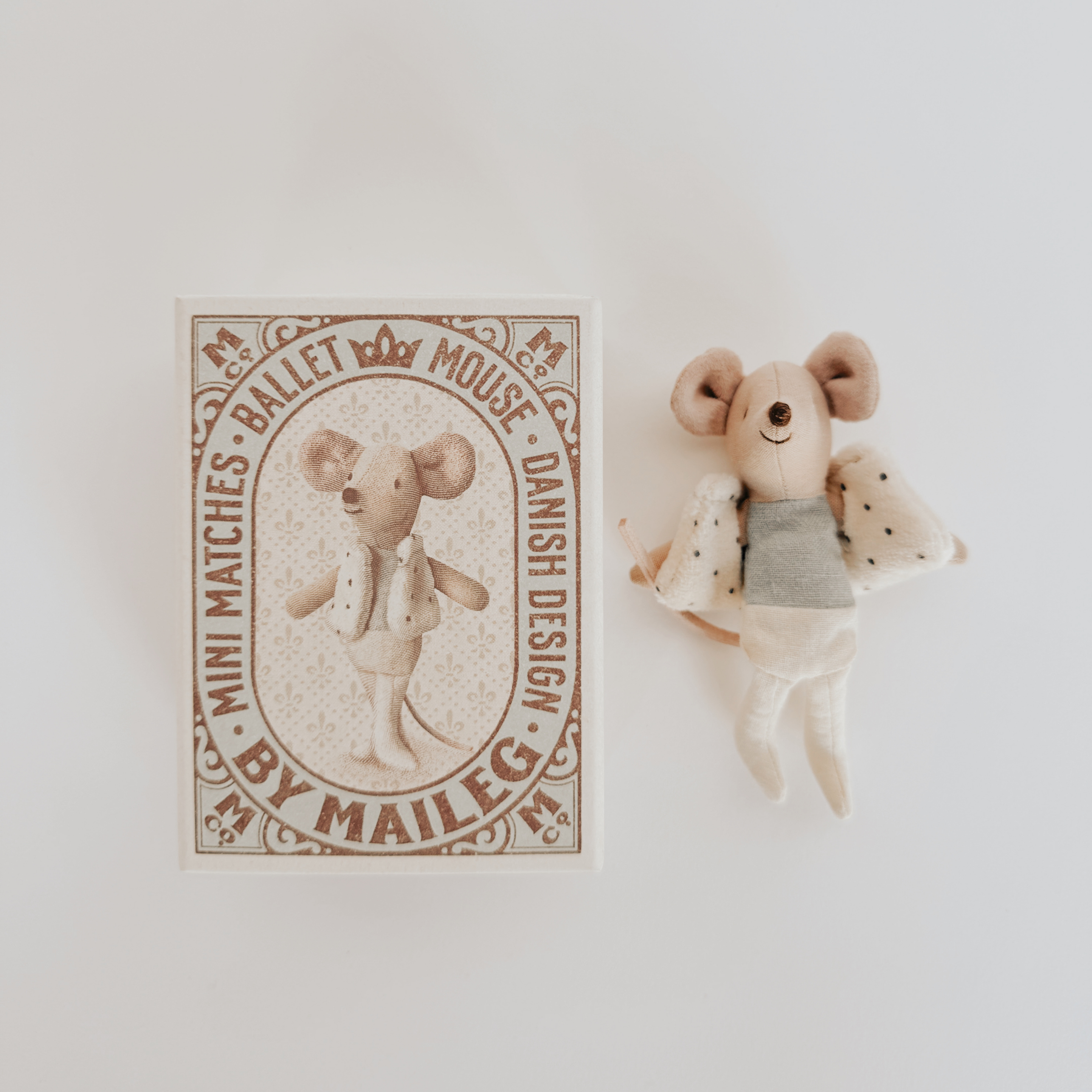 A small dancer mouse in a matchbox labeled Maileg - Dancer in Matchbox – Little Brother Mouse by Grace & Company.