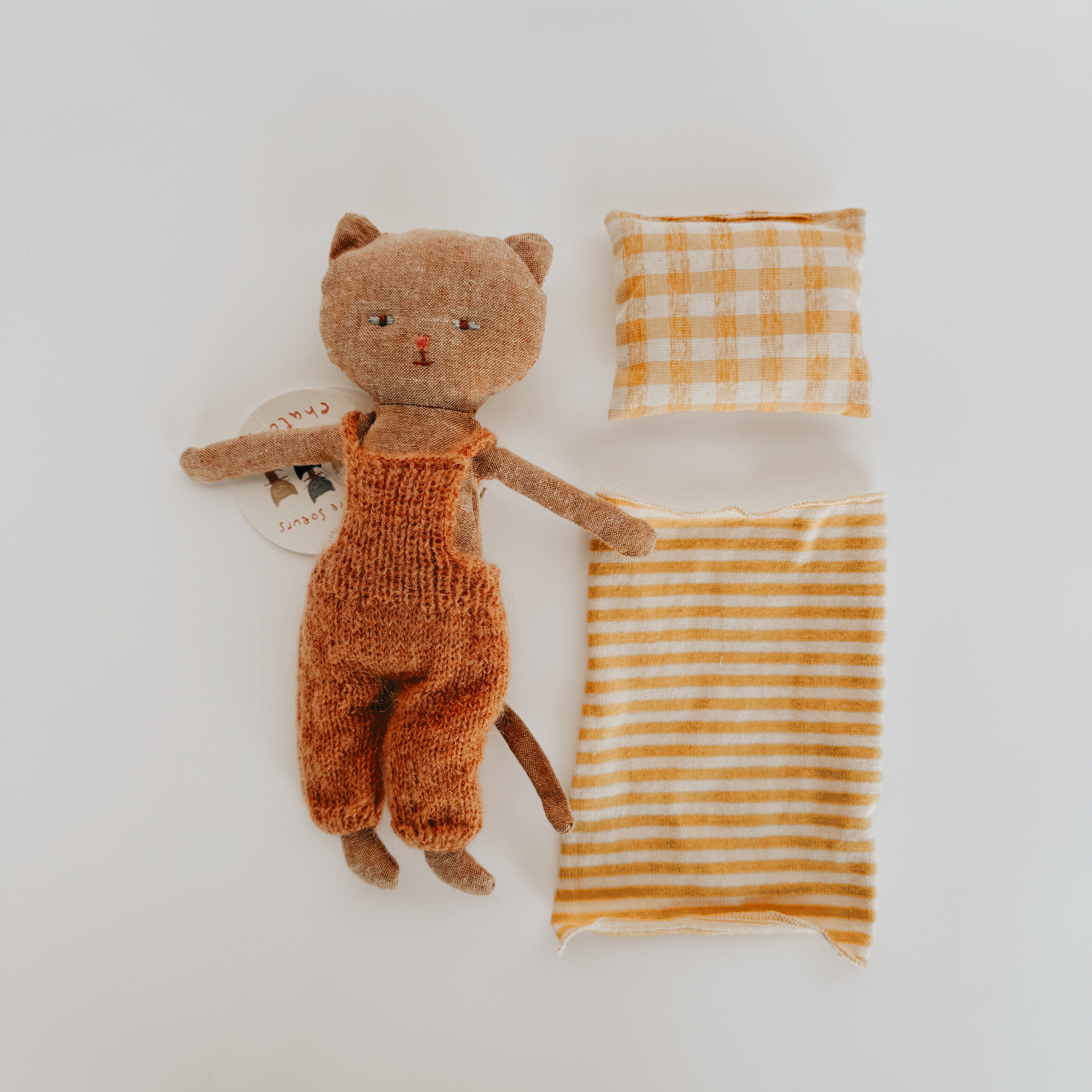Maileg Wooden Bed Mini + Vintage Kitten in Sweater by Grace & Company ltd, shown with pillow and striped blanket.