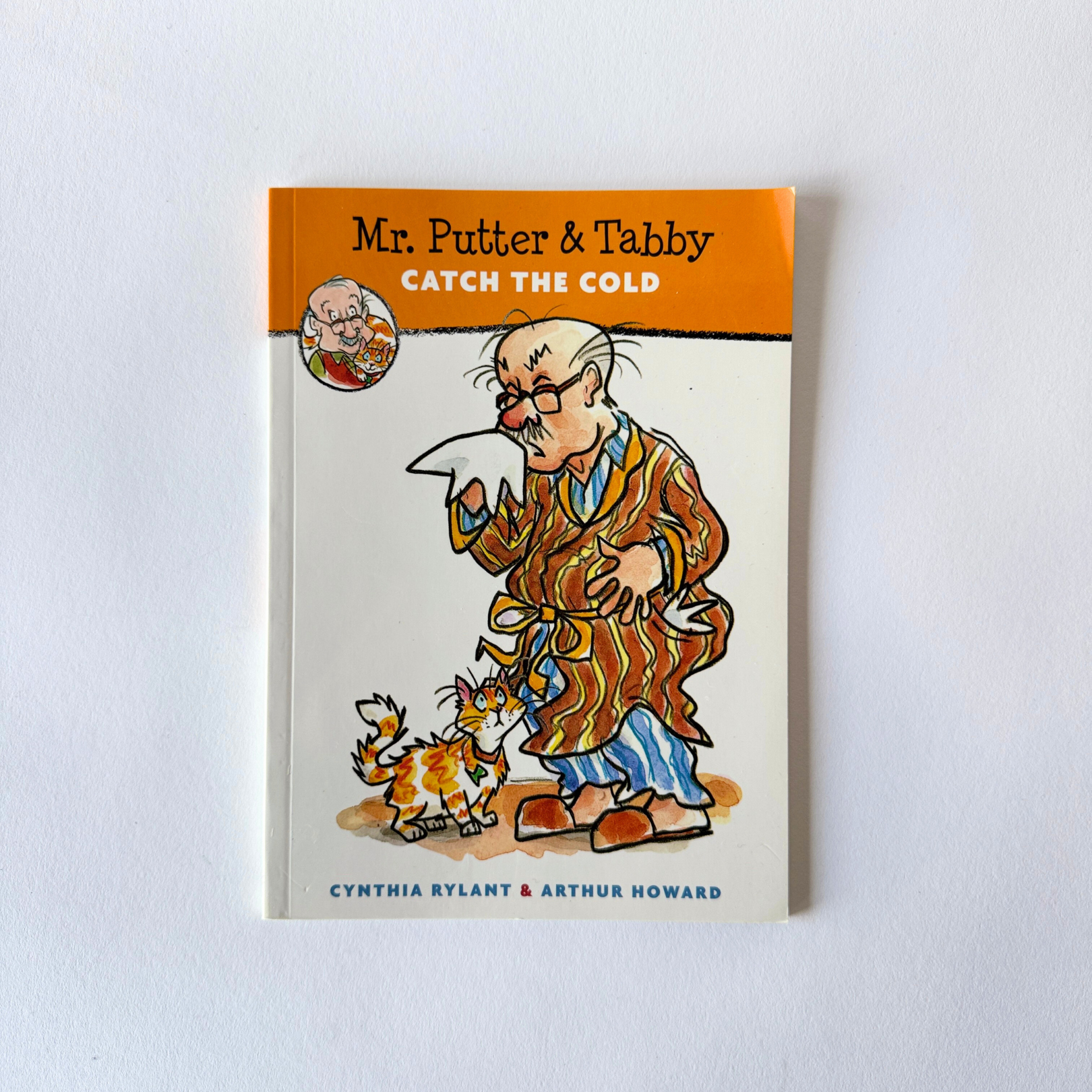 Mr. Putter & Tabby - Catch The Cold by Grace & Company Ltd: an elderly man in a robe with tissue, cat nearby on cover.
