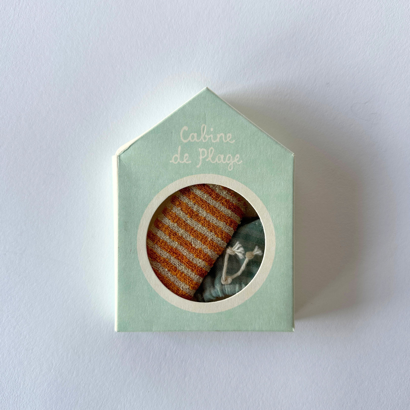 The Maileg de Plage Summer Fun by Grace and Company Ltd is a small mint-green house box with an orange striped interior.