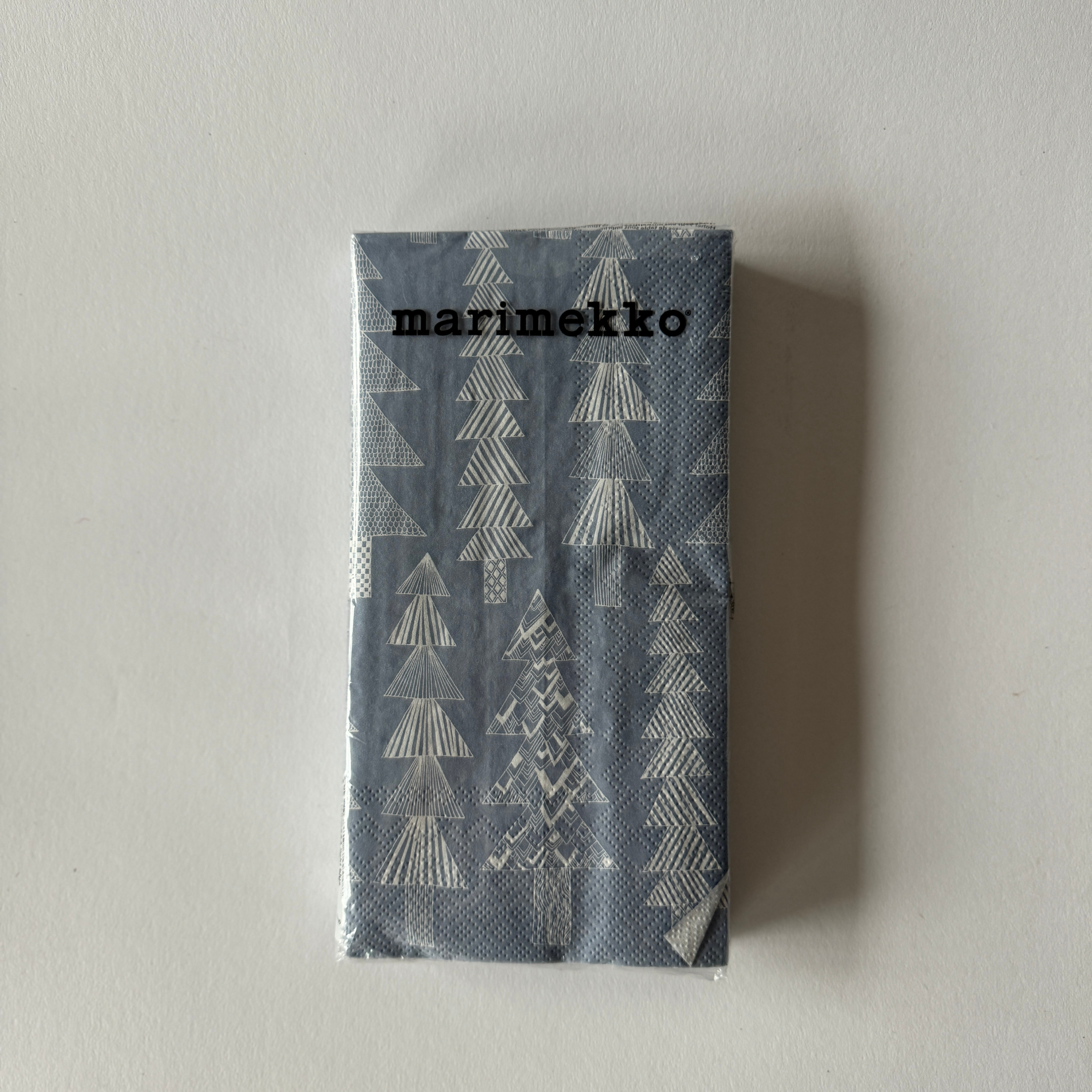 Marimekko - Kuusikossa Guest Napkin by Grace & Company features a gray cover with a white tree pattern.