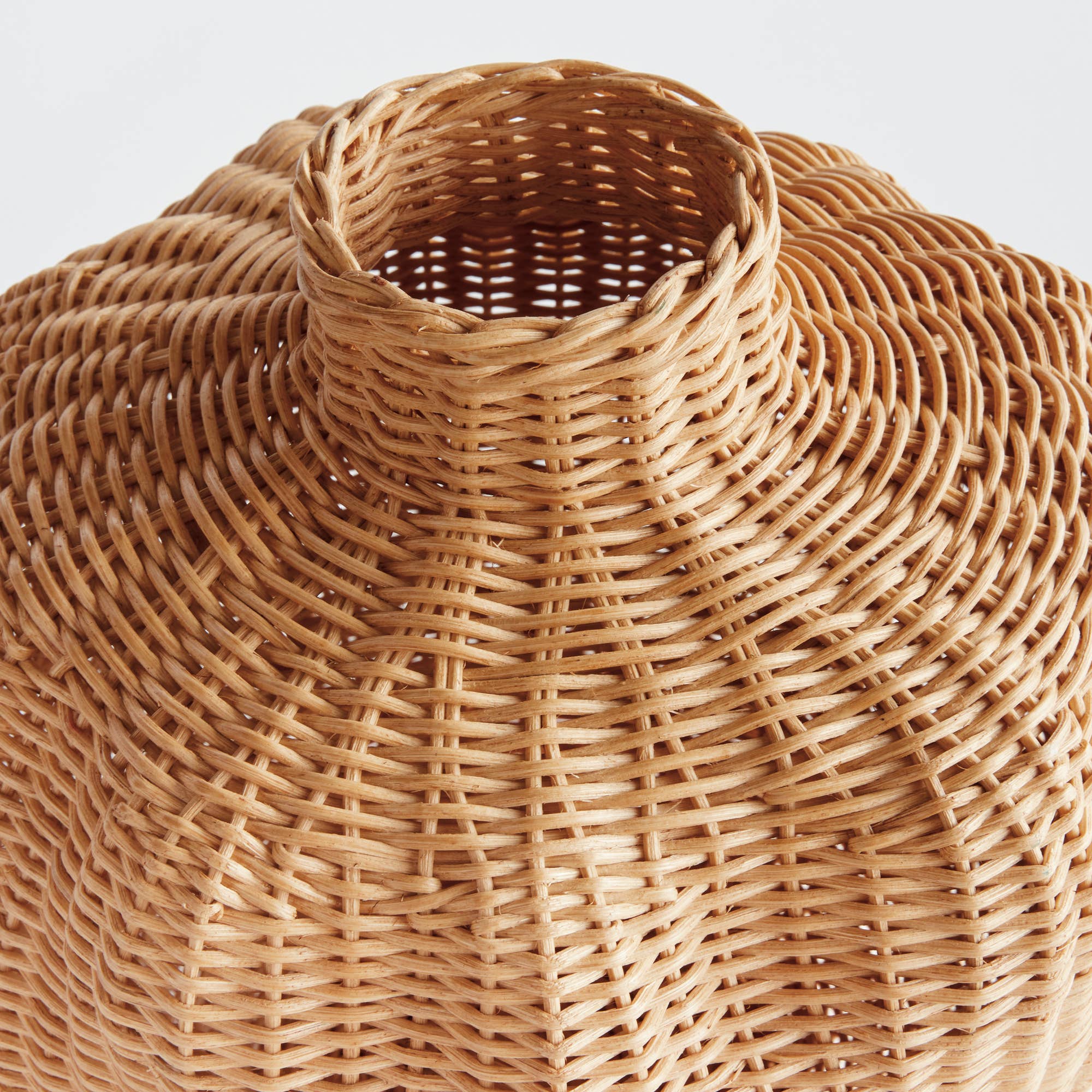 Close-up of the Grace & Company Istanbul Vase, featuring a narrow neck and textured circular wicker pattern.