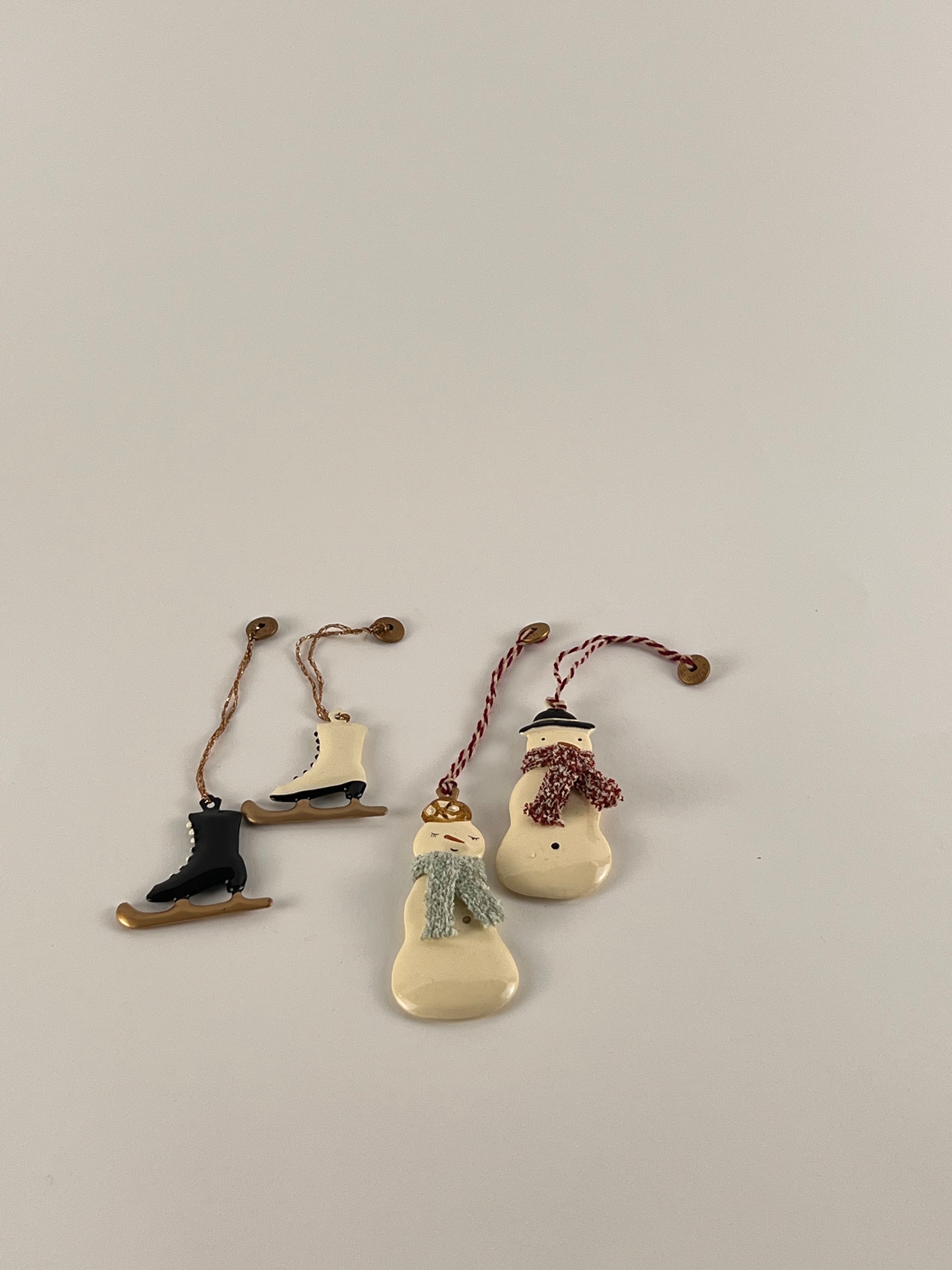 Maileg - Christmas Ornaments Boxed by Grace & Company: 2 ice skates & 2 snowmen with scarves on a light background.