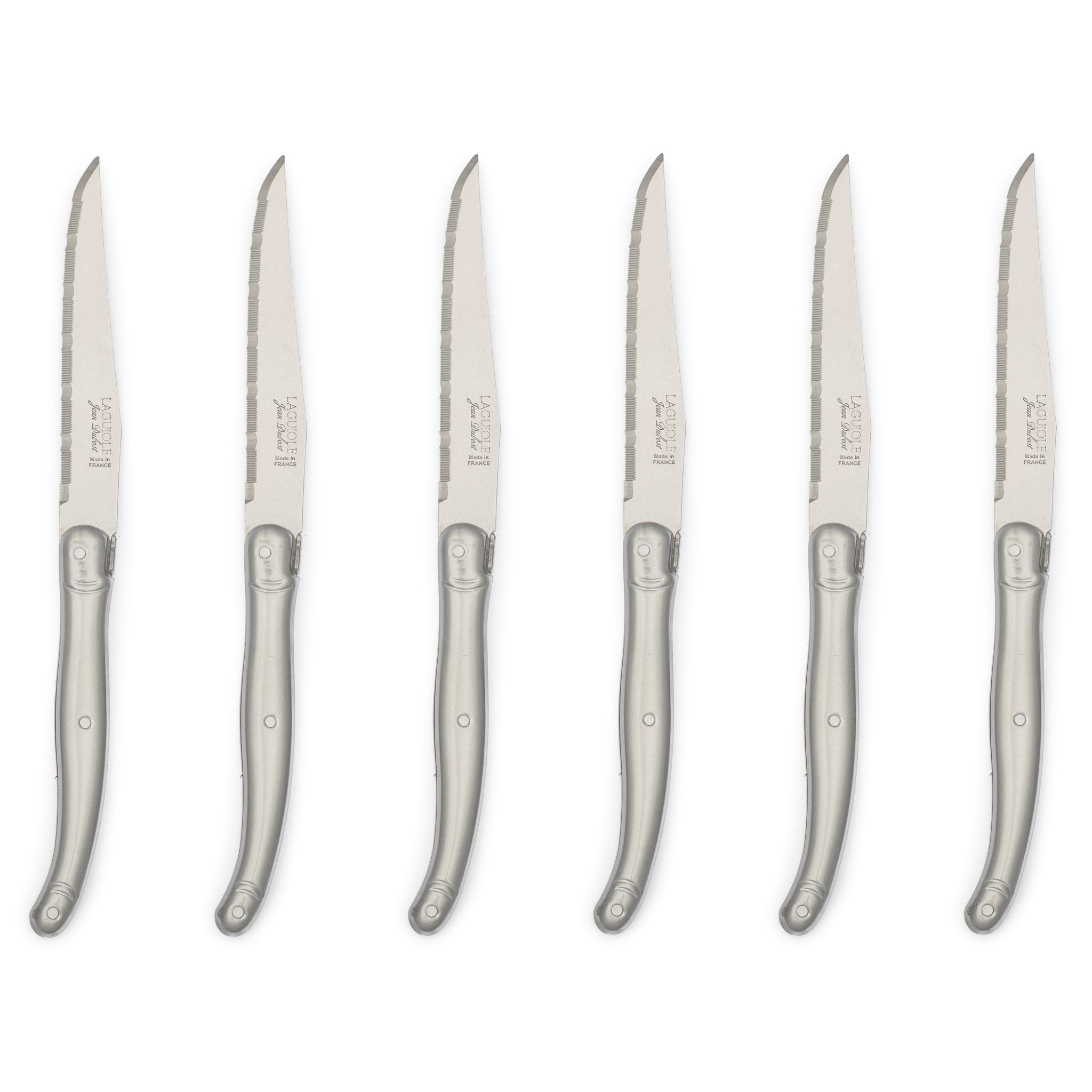 Six Laguiole stainless steel steak knives by Grace & Company ltd, with curved handles, arranged on a white background.