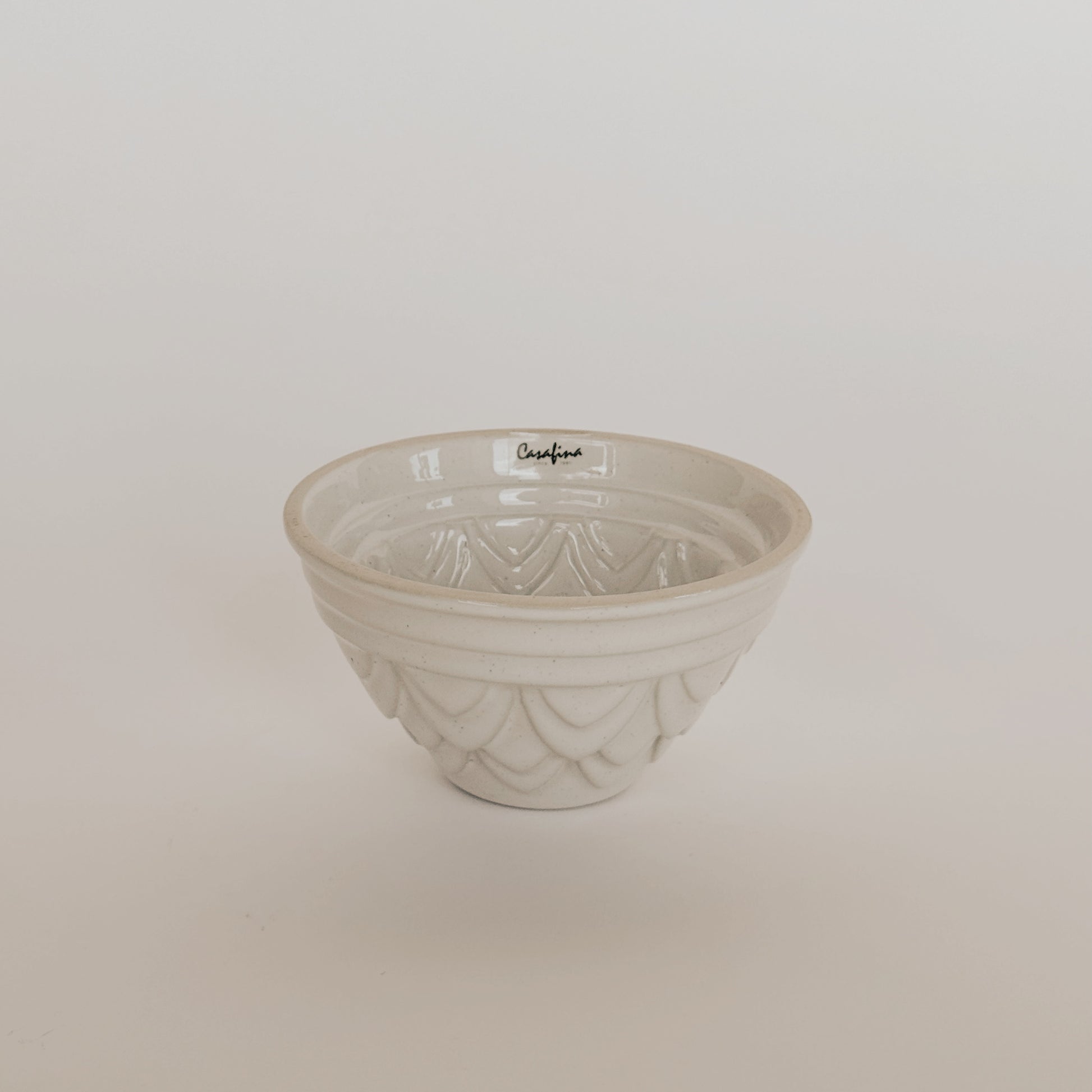 The Casafina Fatoria Cake Pan Set by Grace & Company features textured white ceramic on a simple white backdrop.