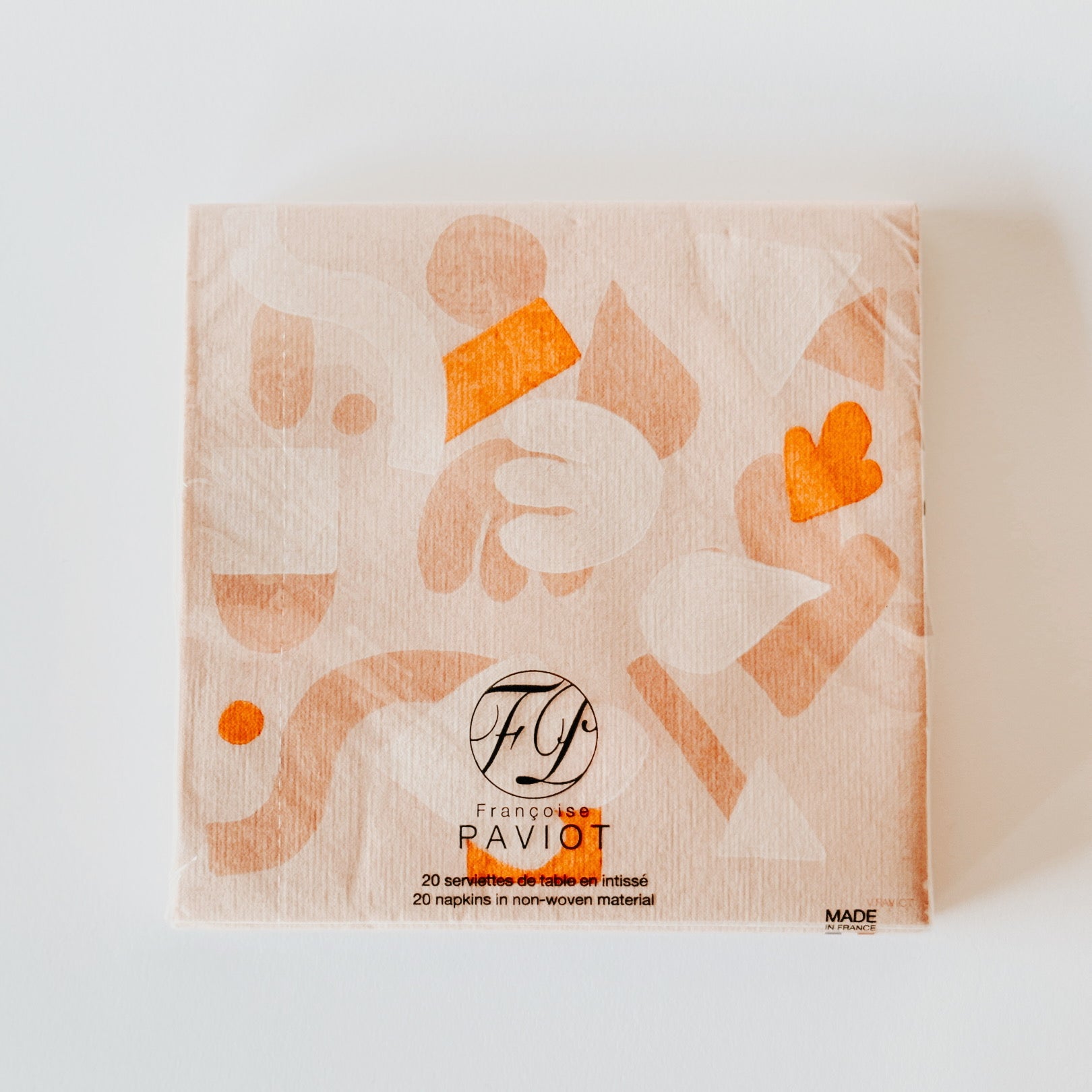 A pack of Grace and Company Ltd Paviot - Gommette Dinner napkins with abstract orange patterns on a light background.