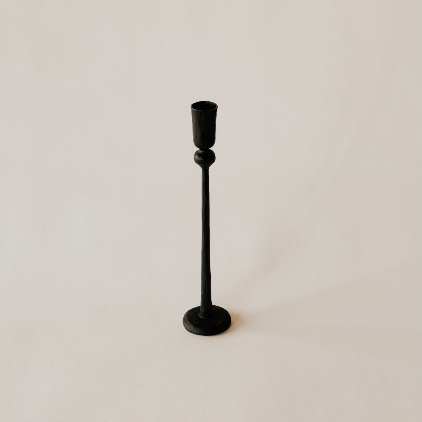 The Canmore Taper Candle Holder by Grace & Company stands upright on a plain, light-colored background.