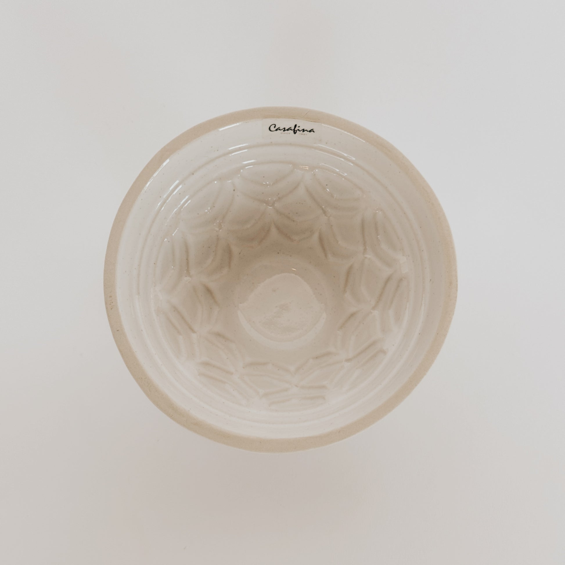 The Casafina - Fatoria Cake Pan Set by Grace & Company, white ceramic with interior texture, seen from above on white.