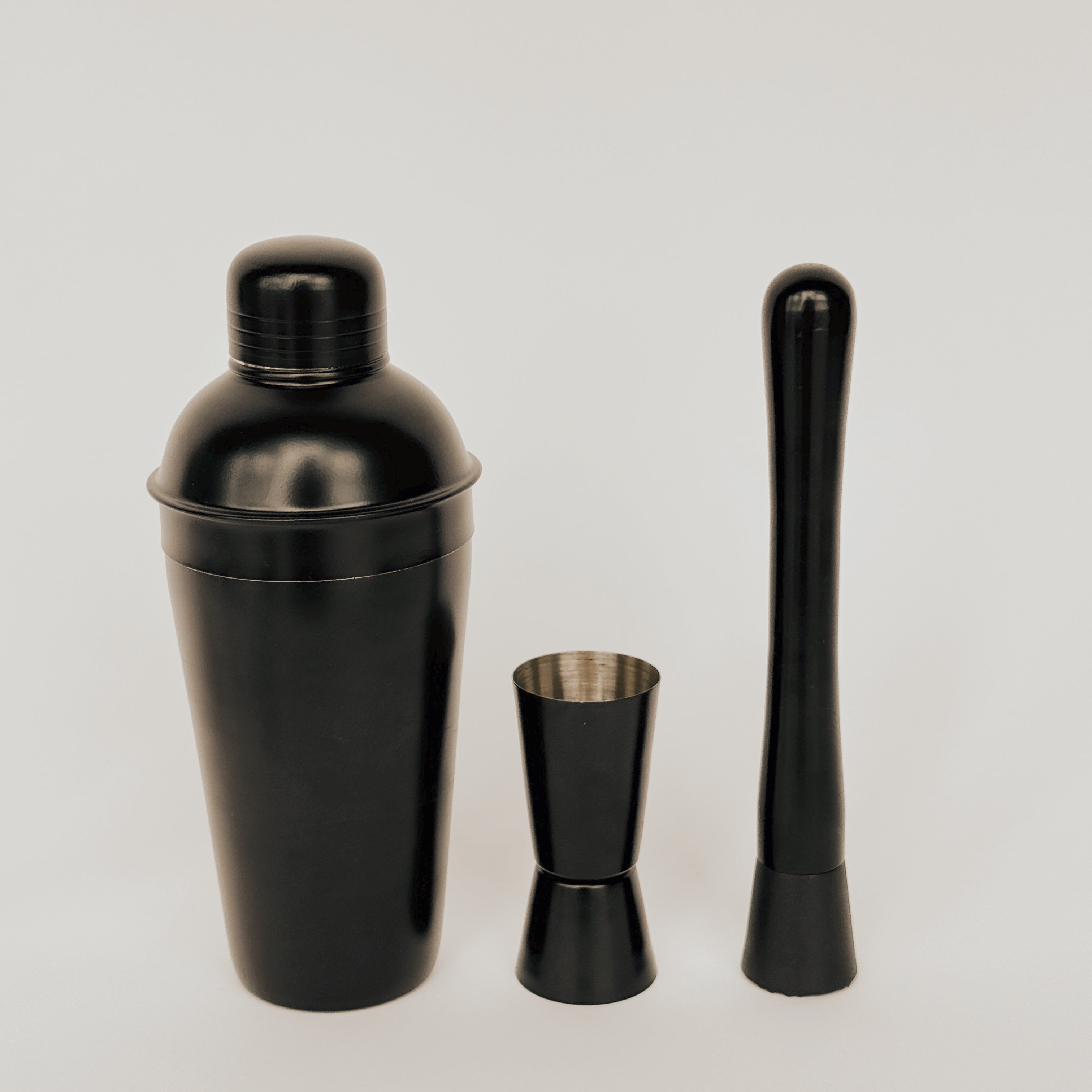 Grace & Company Three-Piece Cocktail Set—shaker, jigger, and muddler on a plain white background.