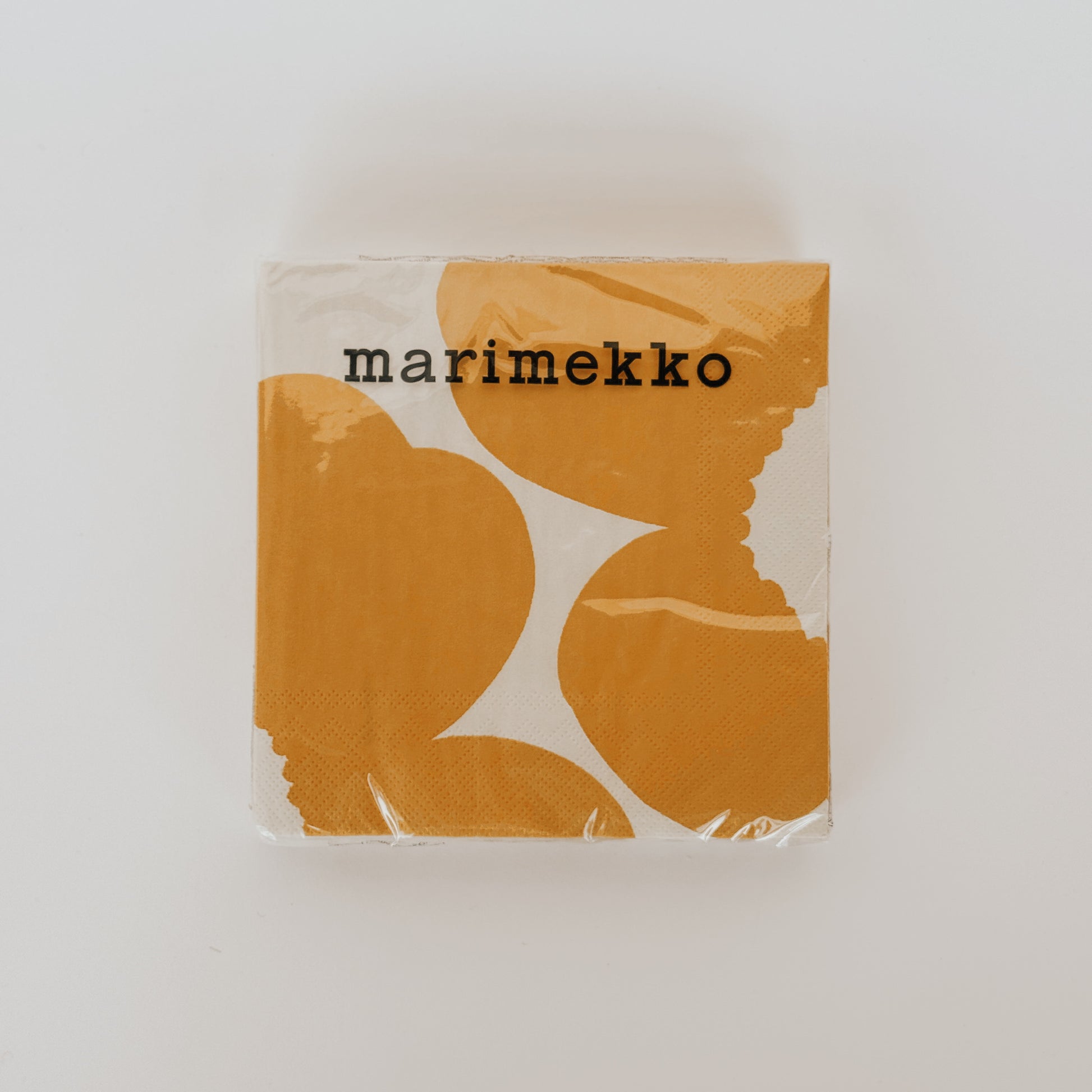 Grace and Company Ltd Marimekko - Unikko Yellow Dinner Napkins feature a bold abstract pattern, packed in plastic.
