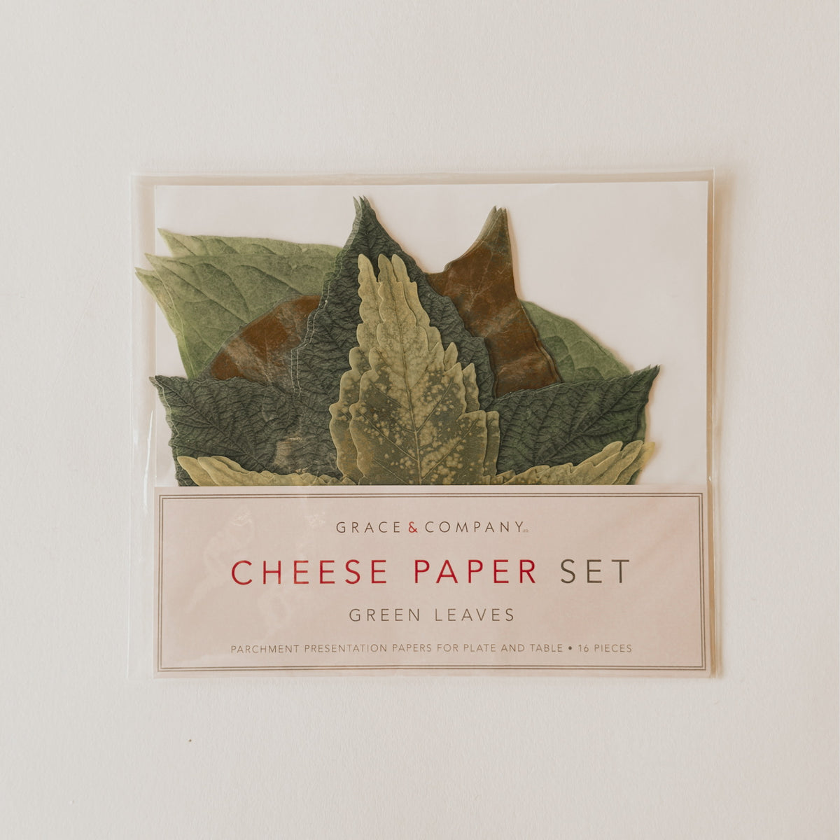 A package of leaf-shaped cheese papers labeled Cheese Paper Set, Green Leaves by Grace & Company.