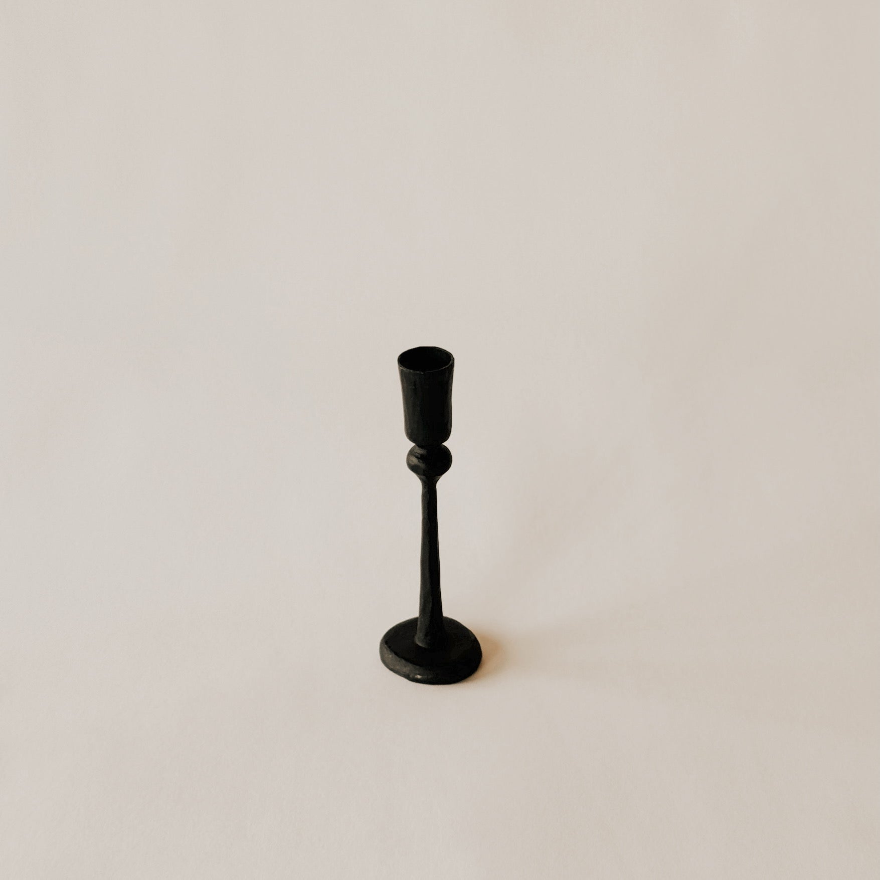 The Canmore Taper Candle Holder by Grace & Company in black on a simple, light background.
