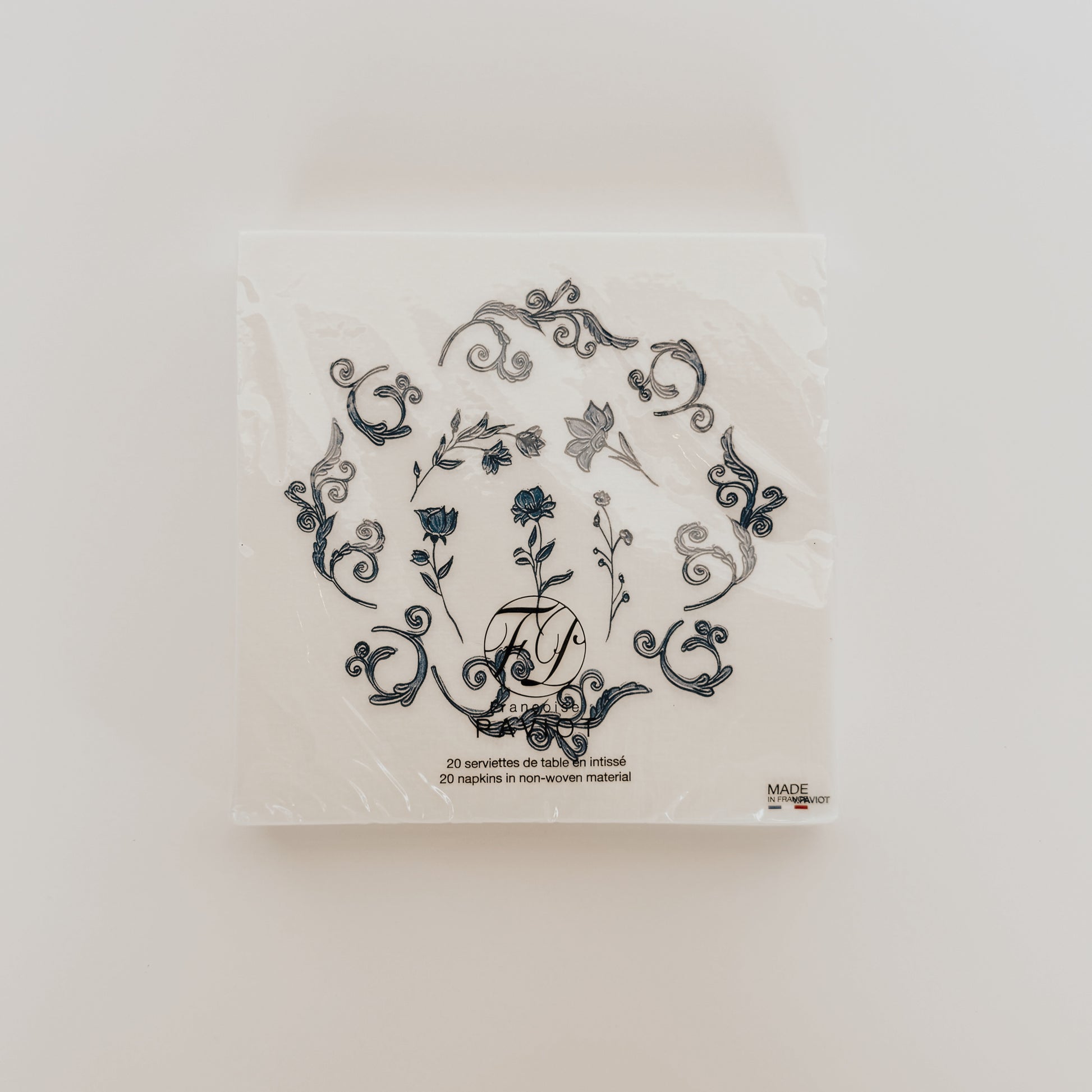 Paviot - Regence Bleu Dinner Napkin by Grace and Company Ltd, in plastic wrap, on a plain white background.