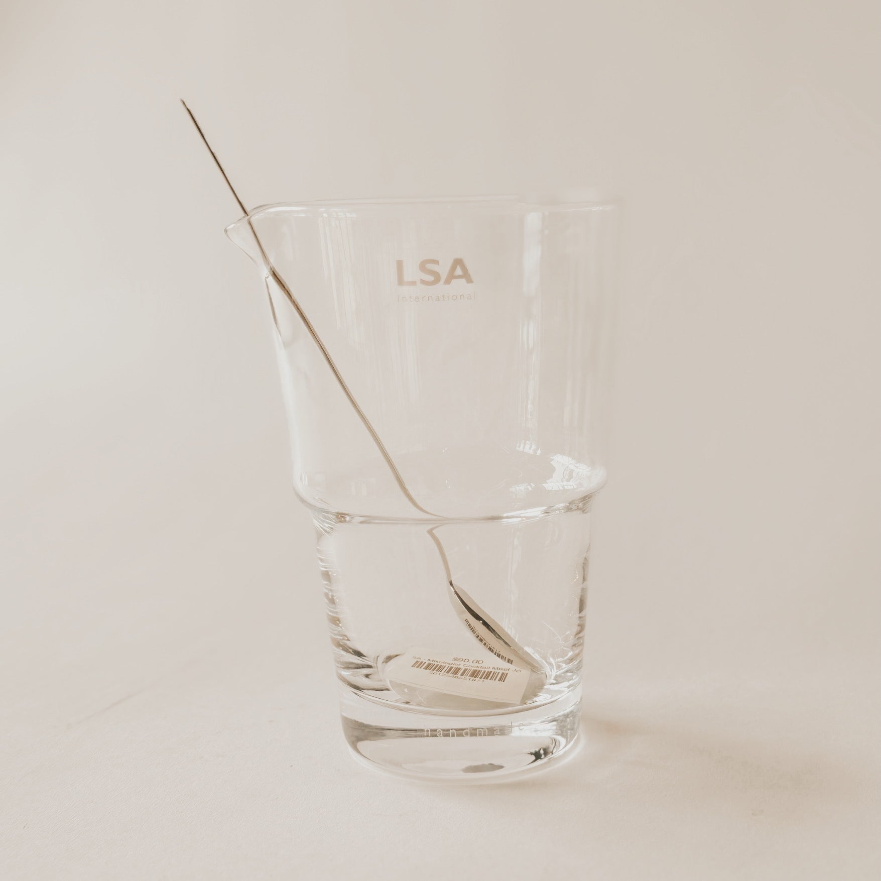 The Grace & Company LSA - Mixologist Cocktail Mixer Jug with a metal stirrer on a plain light background.