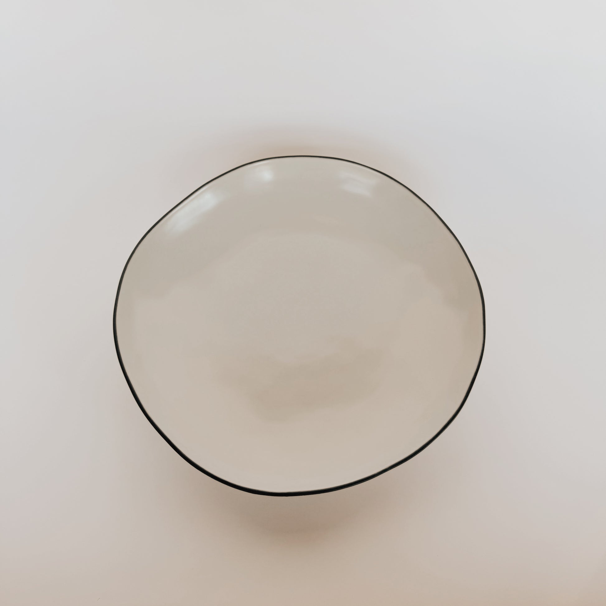 The Stacked Organic Serving Bowl - Salt by Grace & Company ltd is an off-white, irregular ceramic bowl on a white background.