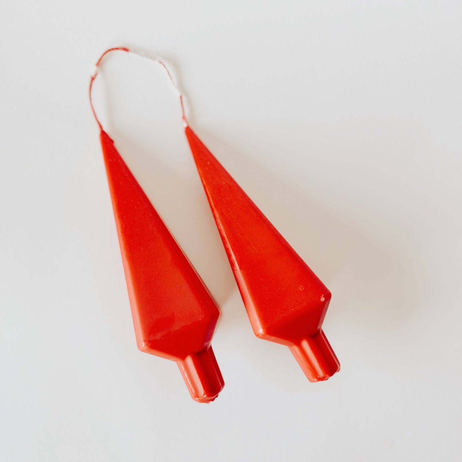 Two red tree-shaped Grace & Company Danish Candles connected by a string, displayed on a white background.