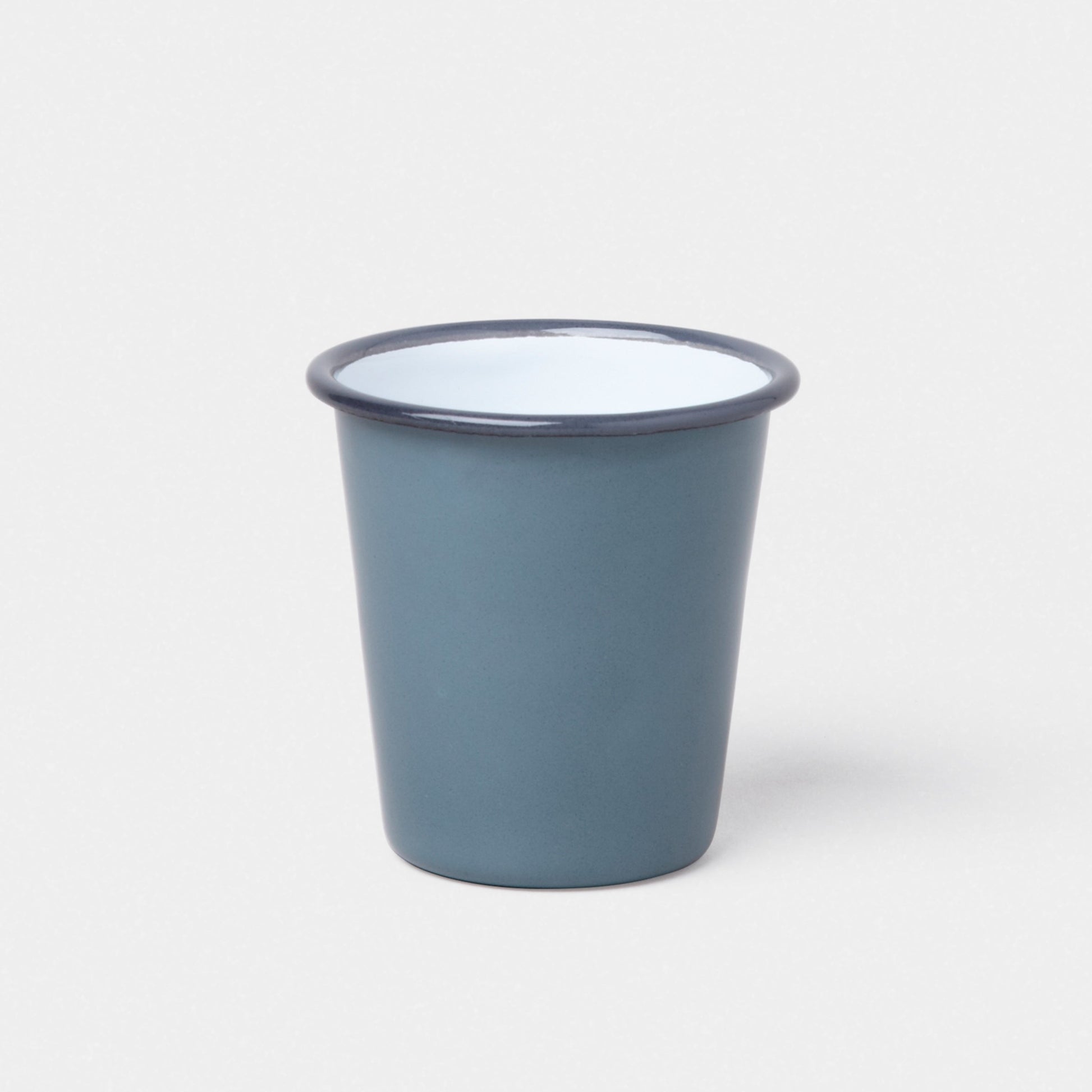 The Falcon Enamelware Tumbler by Grace & Company in blue with a white interior and dark rim on a plain white background.