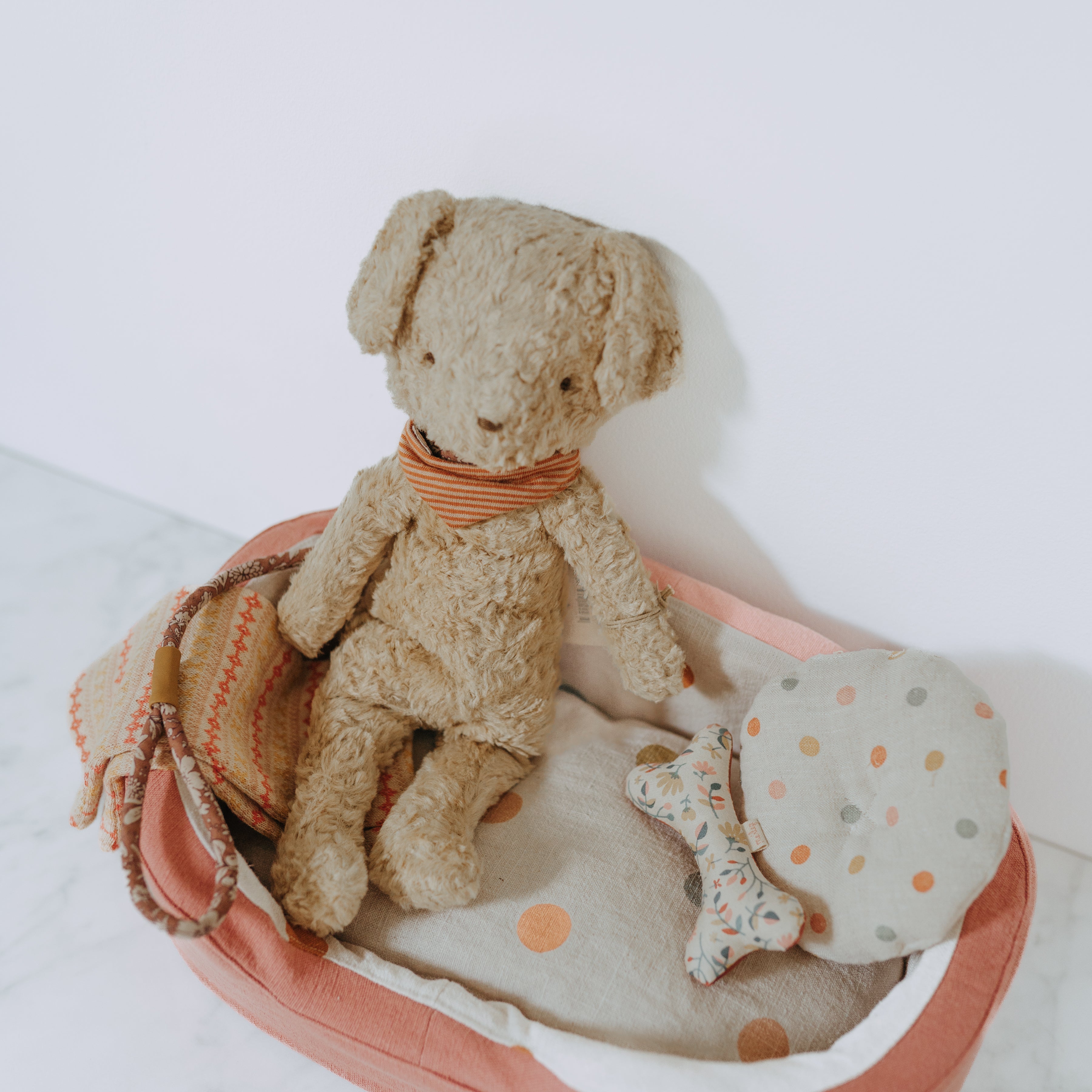 The Grace & Company Maileg - My First Puppy Bundle includes a plush puppy, fabric basket, polka-dot bedding, and toy bone.