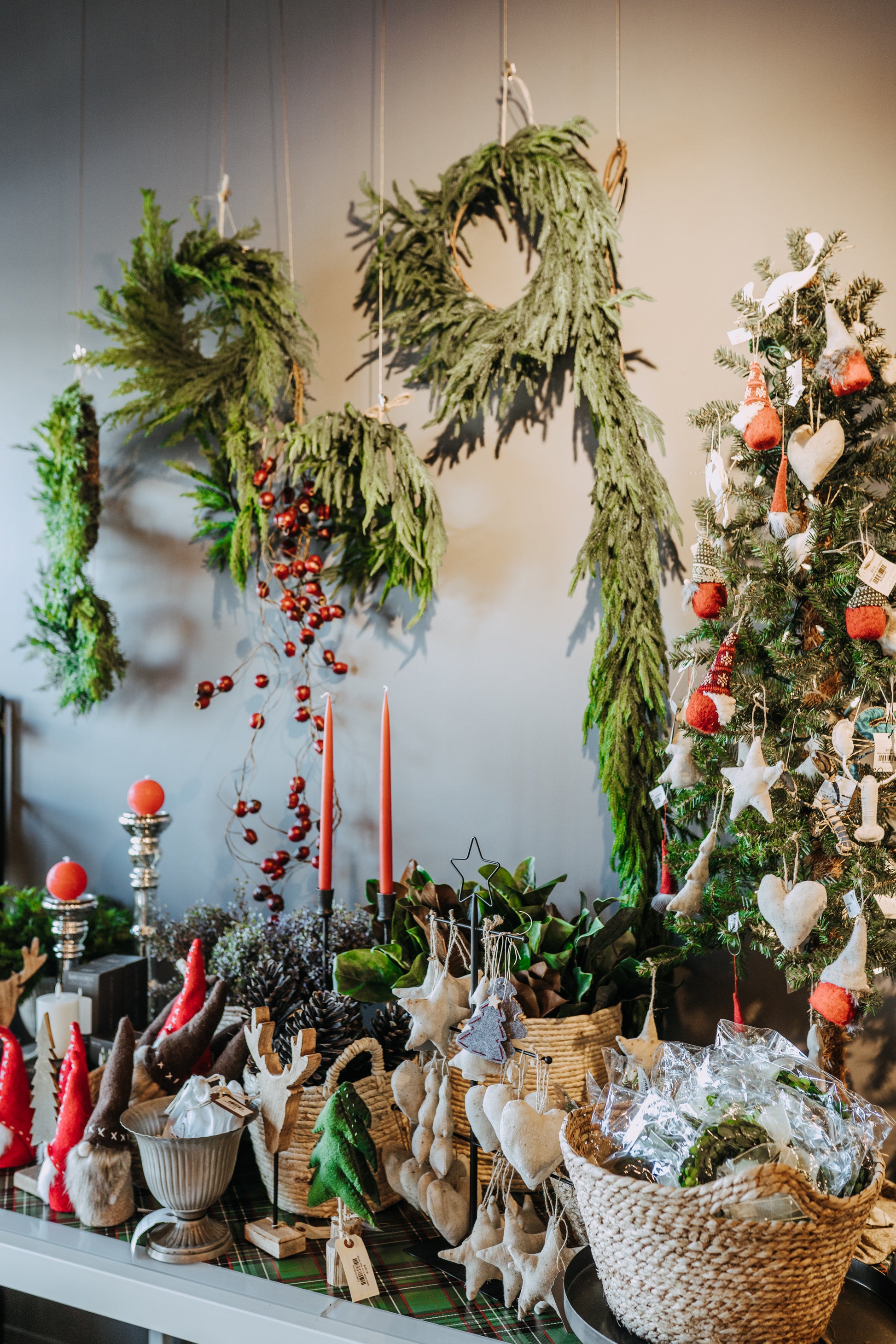 Table with Grace & Companys Fresh Touch Norfolk Pine Collection, handmade ornaments, wreaths, candles & Christmas tree.