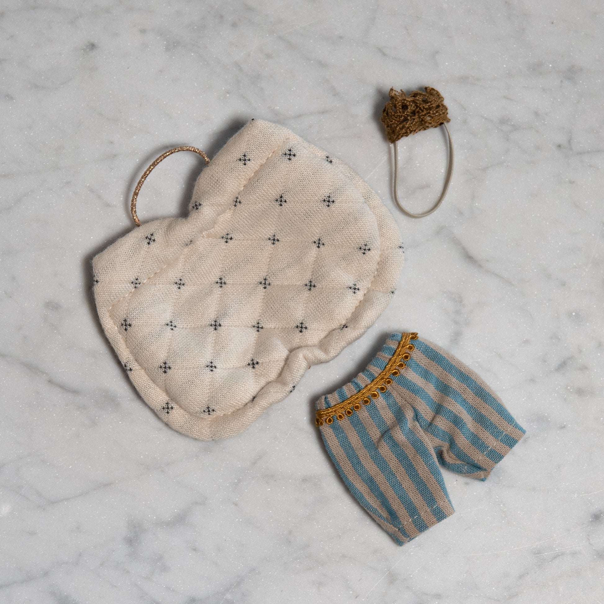 Maileg - Clothing for Mice by Grace & Company: blue/beige shorts, patterned pillow, and brown knit hat on marble.