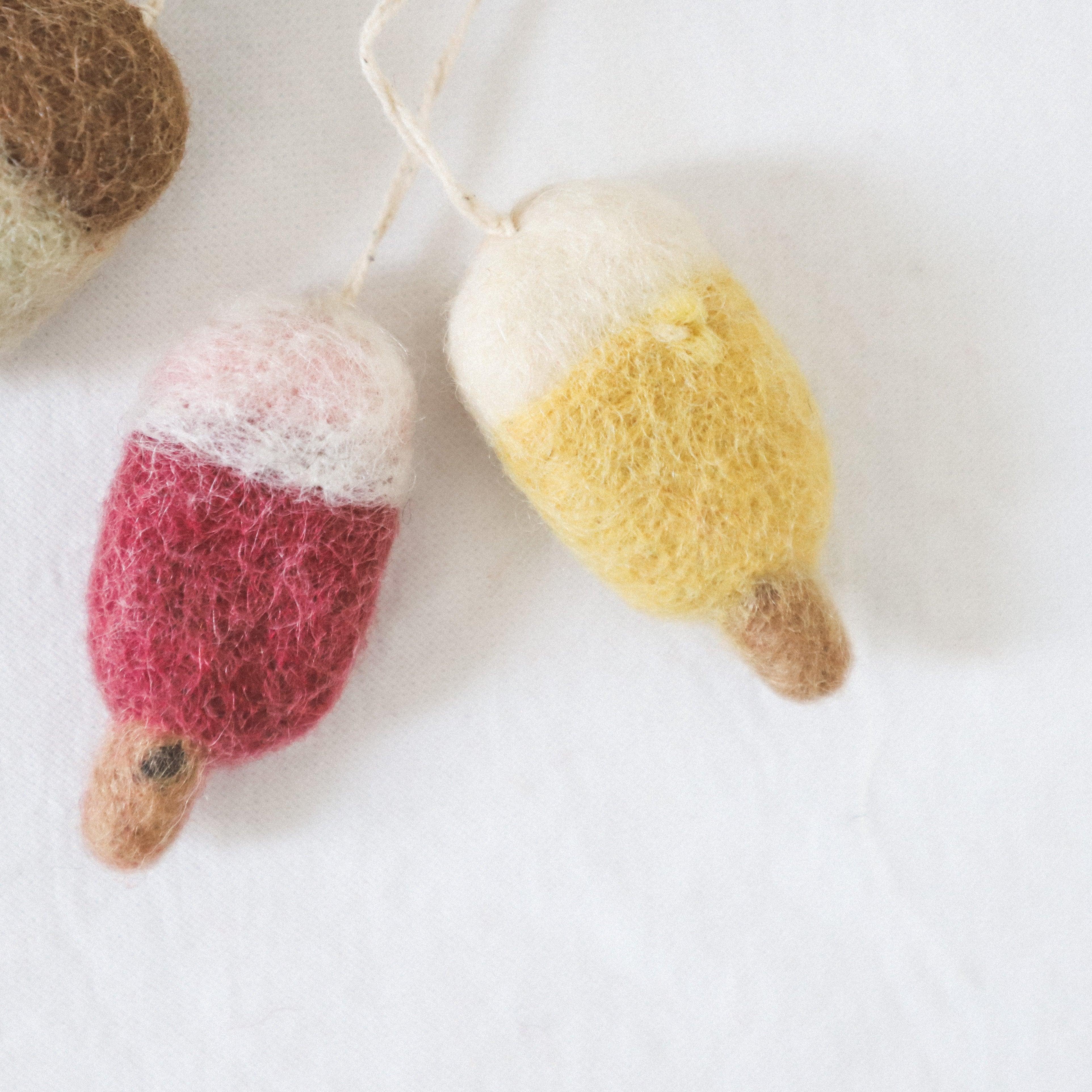 Two Grace and Company Ltd Scandi Wool Ice Lolly Ornaments, red/white and yellow/white, on a white background.