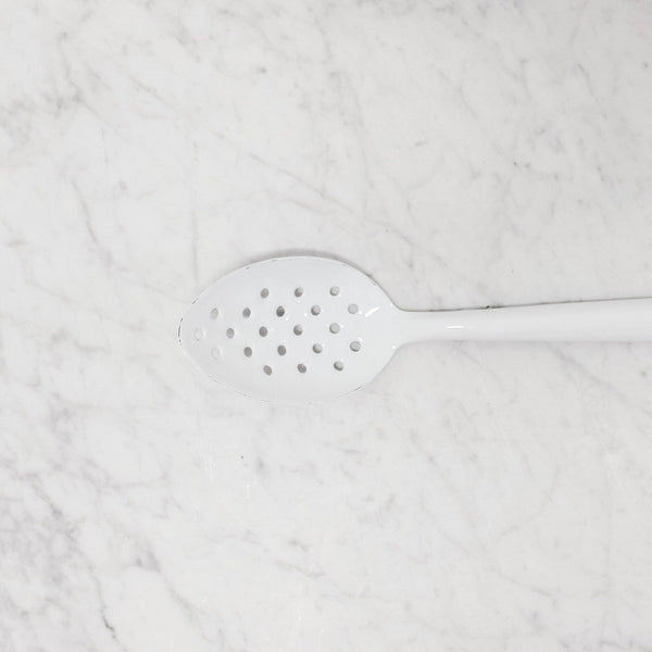 white enamel slotted spoon by Falcon enamelware