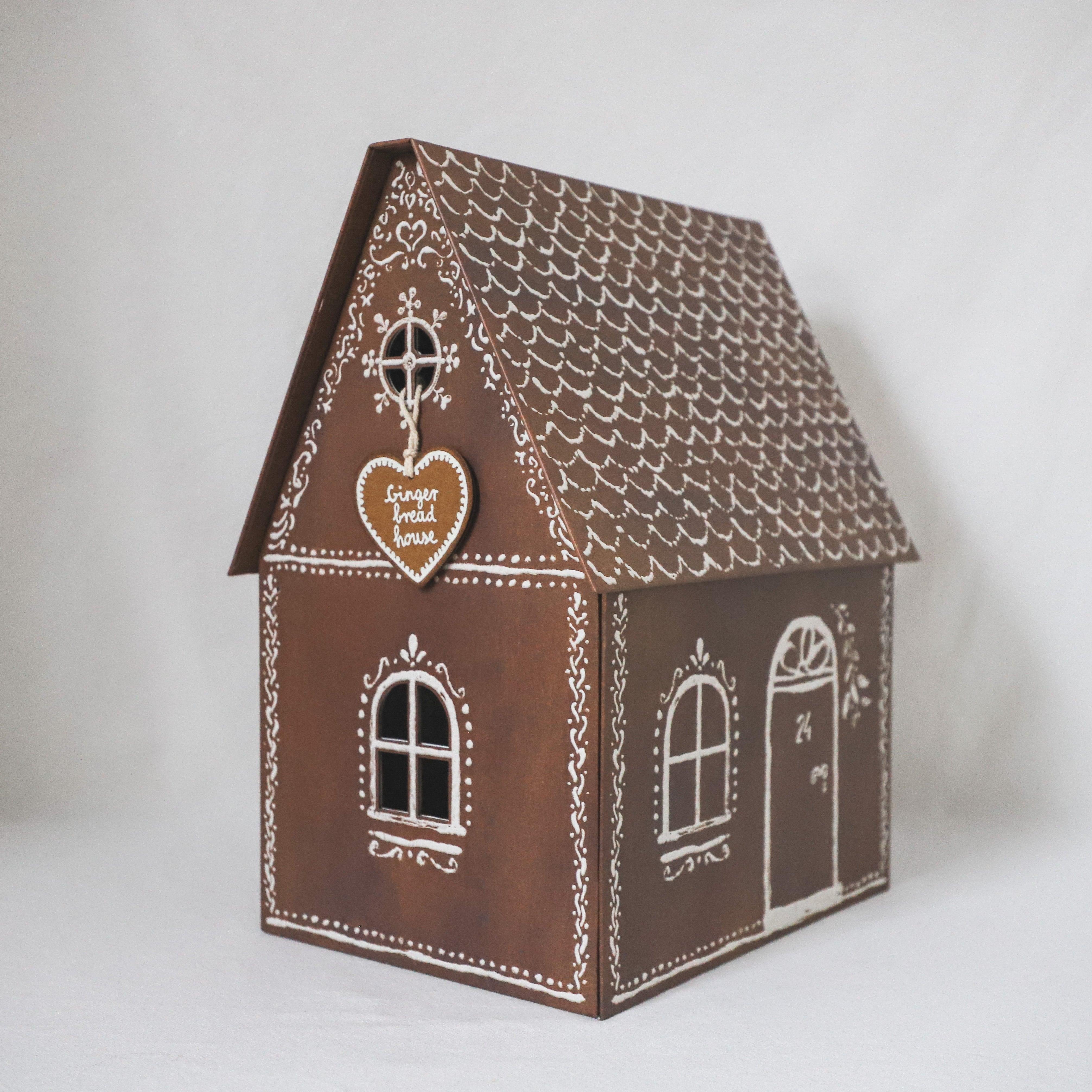 The Maileg - Gingerbread House by Grace & Company features white icing designs and a heart cookie on the front.