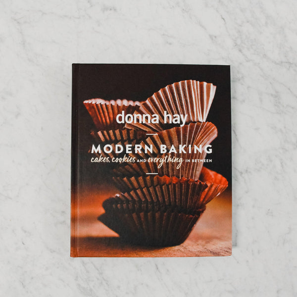 front cover of donna hay's modern baking. cover features stacked muffin cups