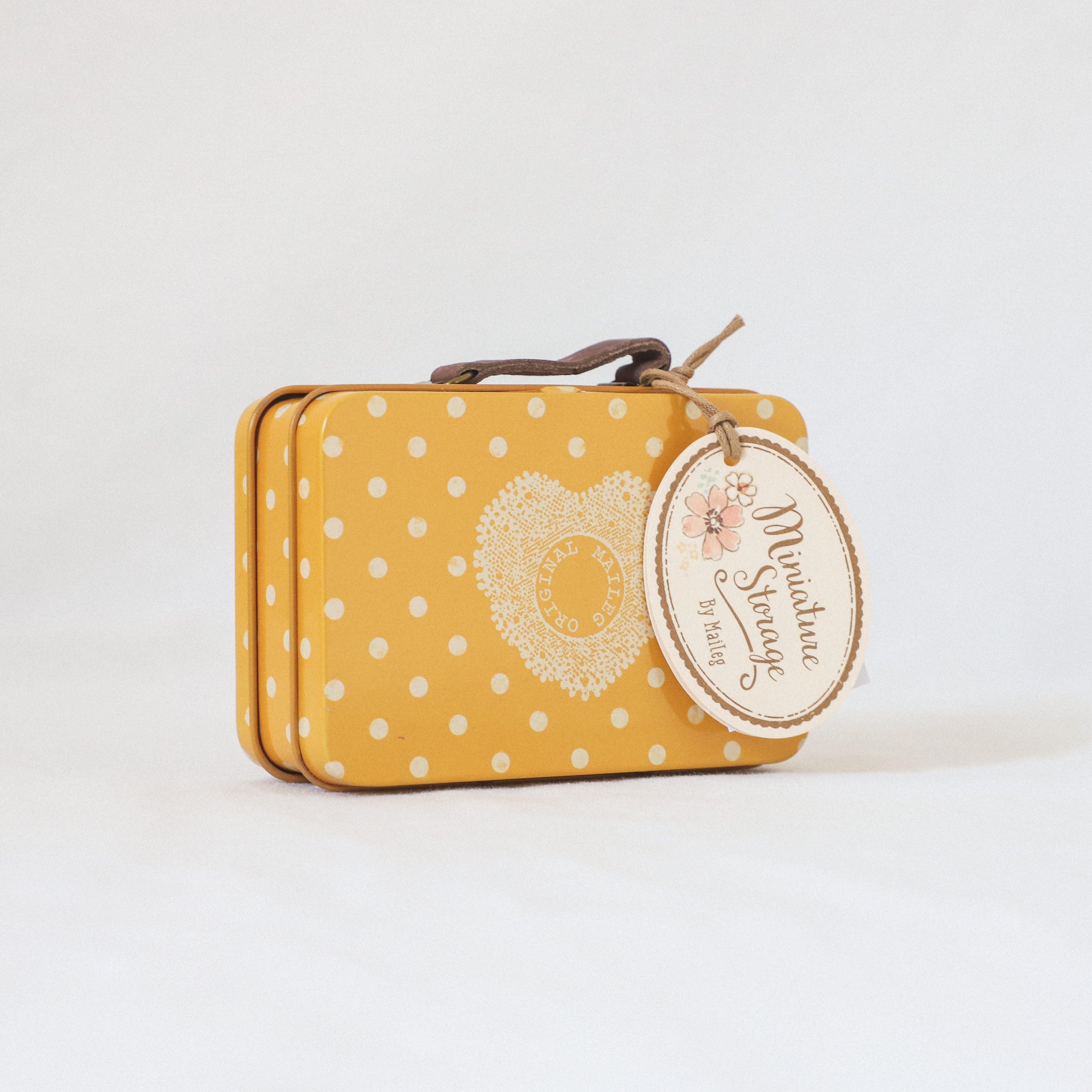 Yellow dotted Maileg suitcase by Grace & Company, featuring a heart design and round floral tag.