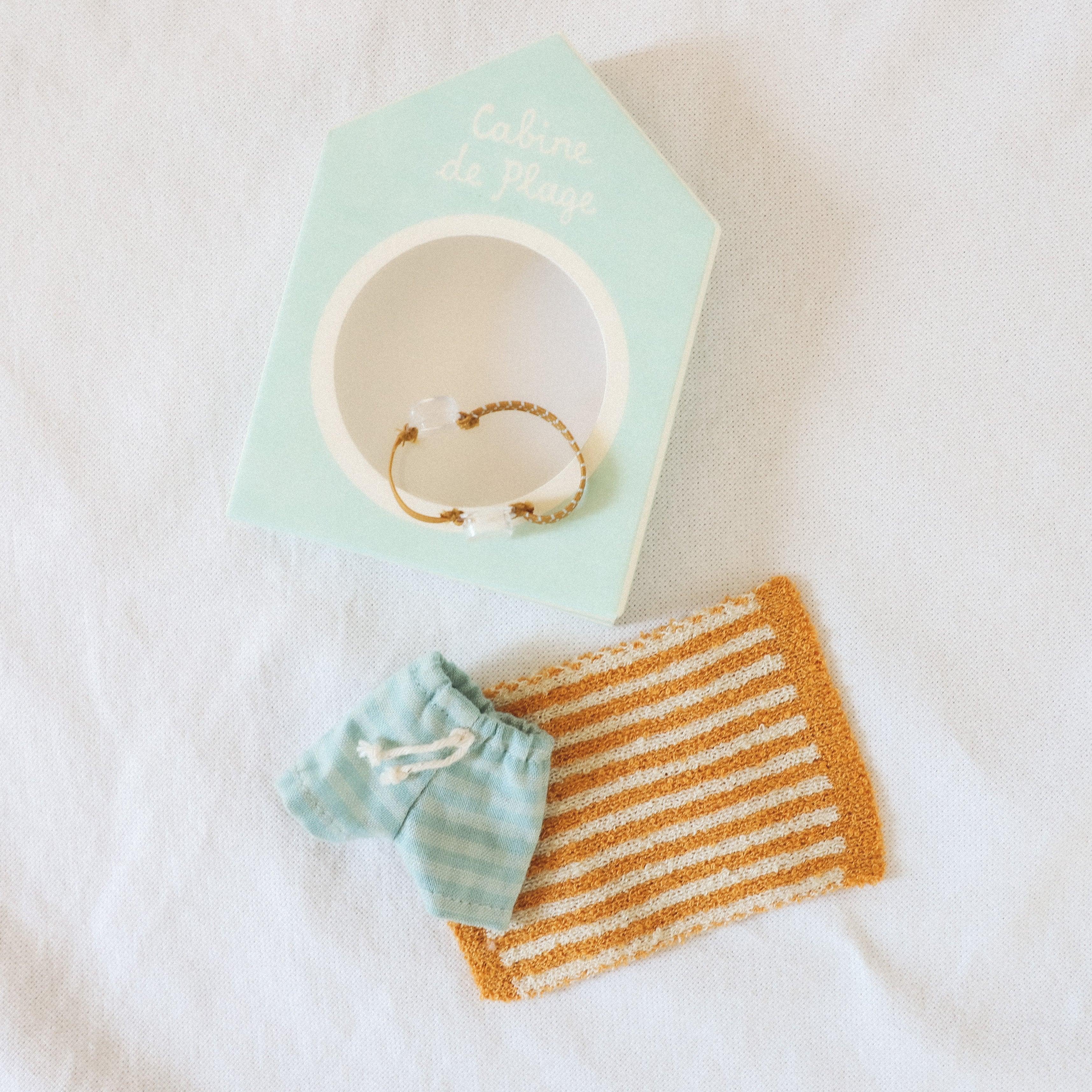 Maileg - Cabine de Plage Beachset Big Brother by Grace & Company: blue striped shorts, gold bracelet, and mat.