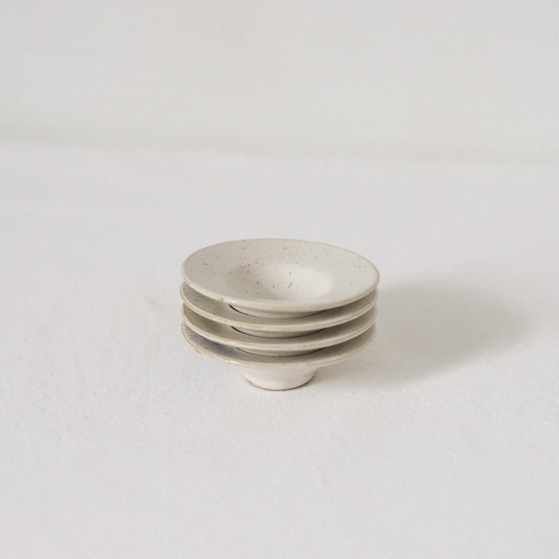 The Pion tiny bowls set of 2 by Grace & Company, stacked on a white surface with a minimal backdrop.