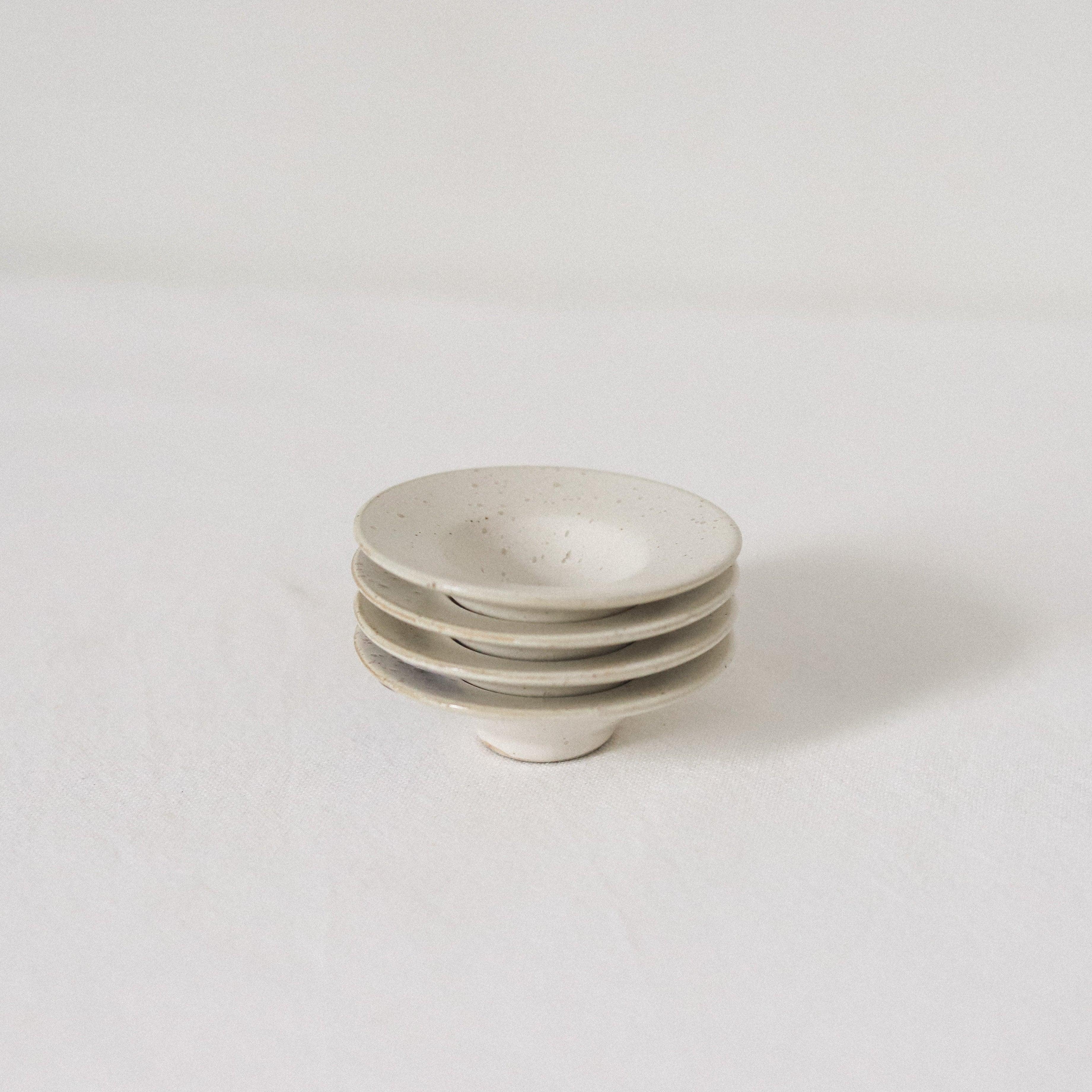 The Pion tiny bowls set of 2 by Grace & Company, stacked on a white surface with a minimal backdrop.