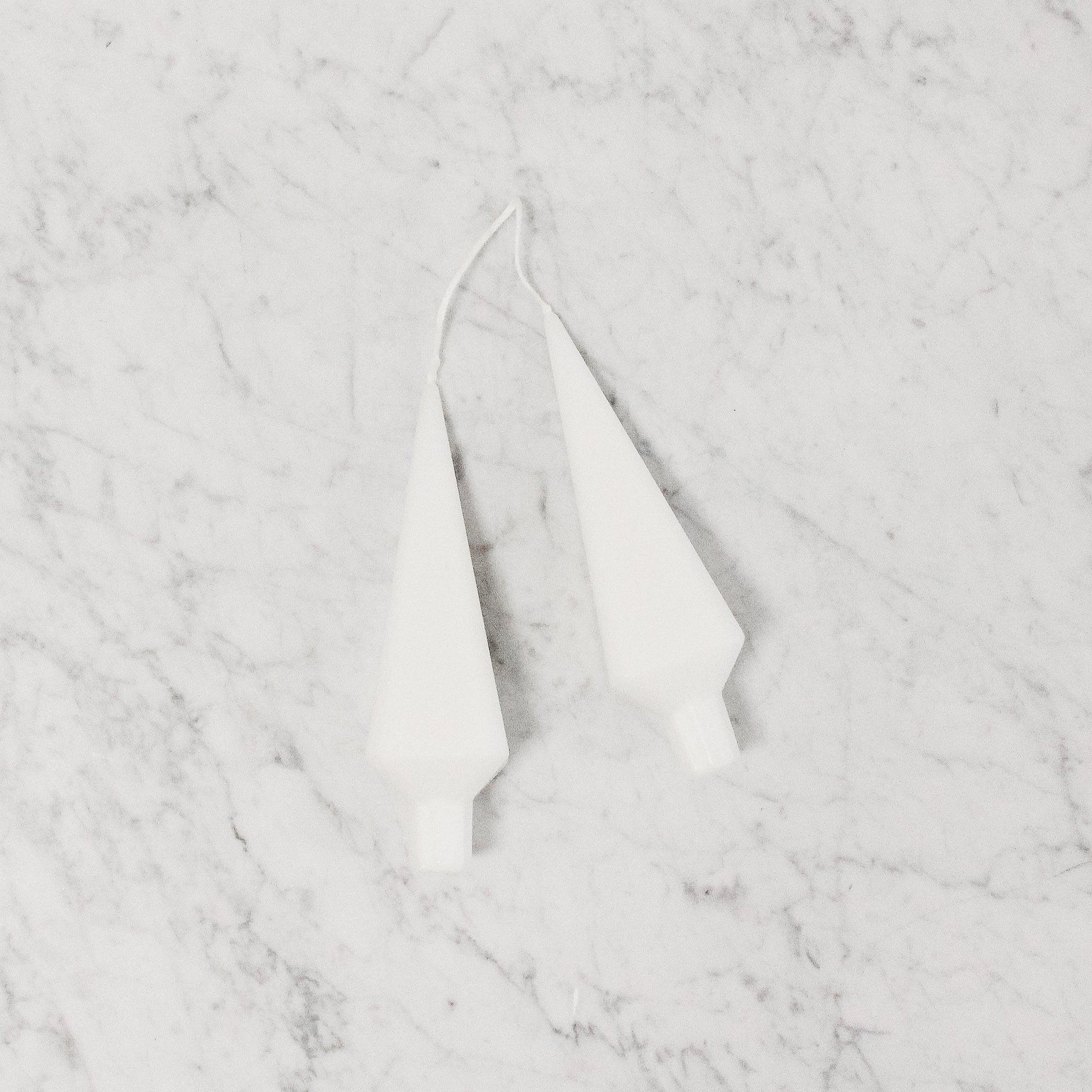 pair of stylized tree shaped candles in white