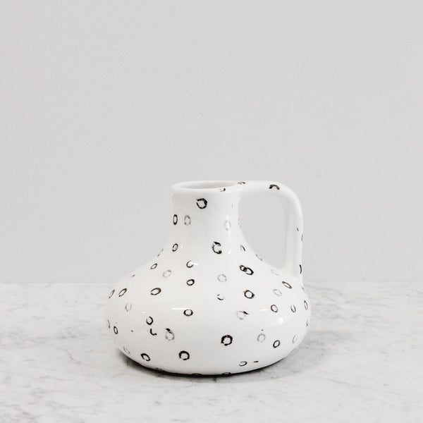 white dottle vase with handle