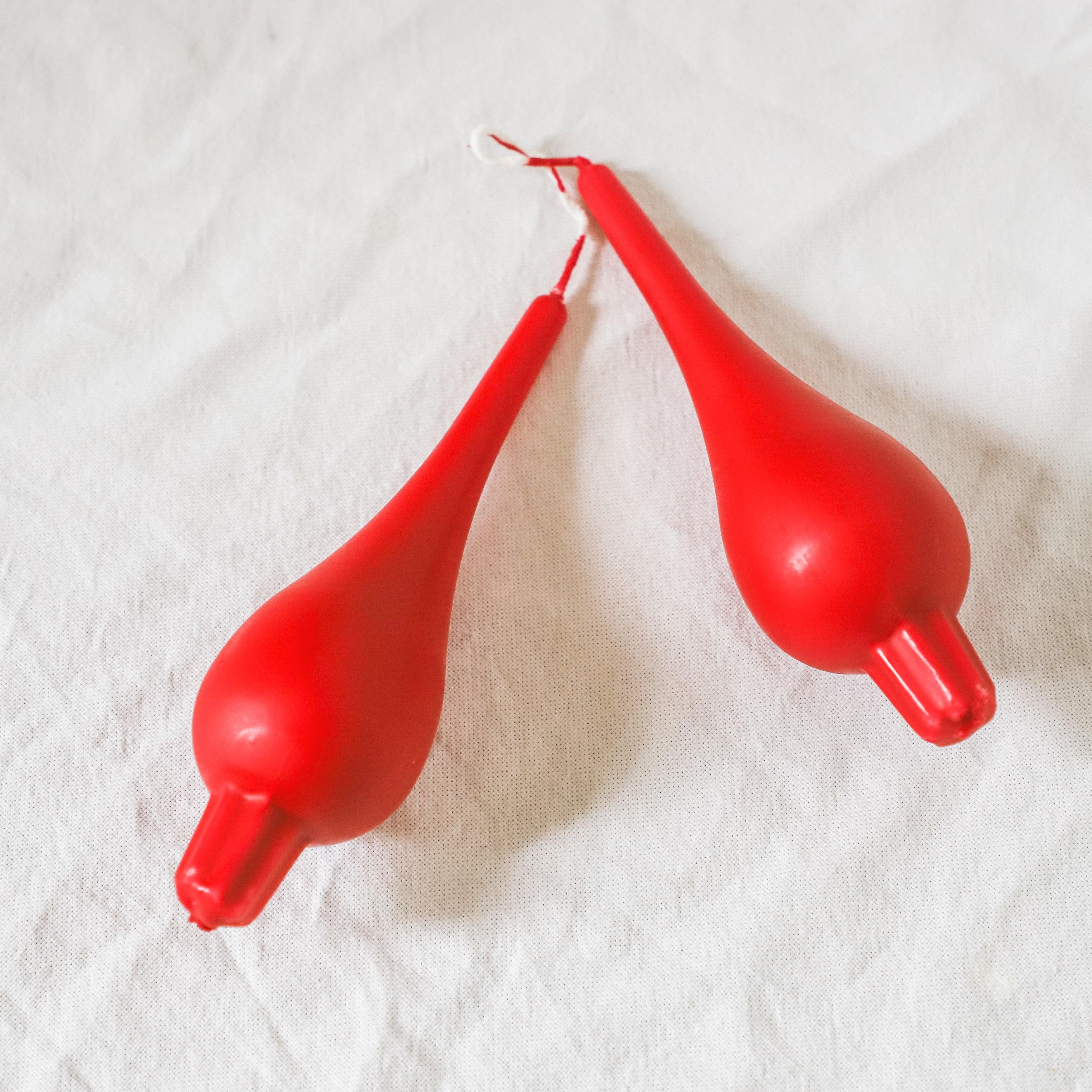 Two Danish Candle Drop Pair by Grace & Company ltd lying on white fabric.