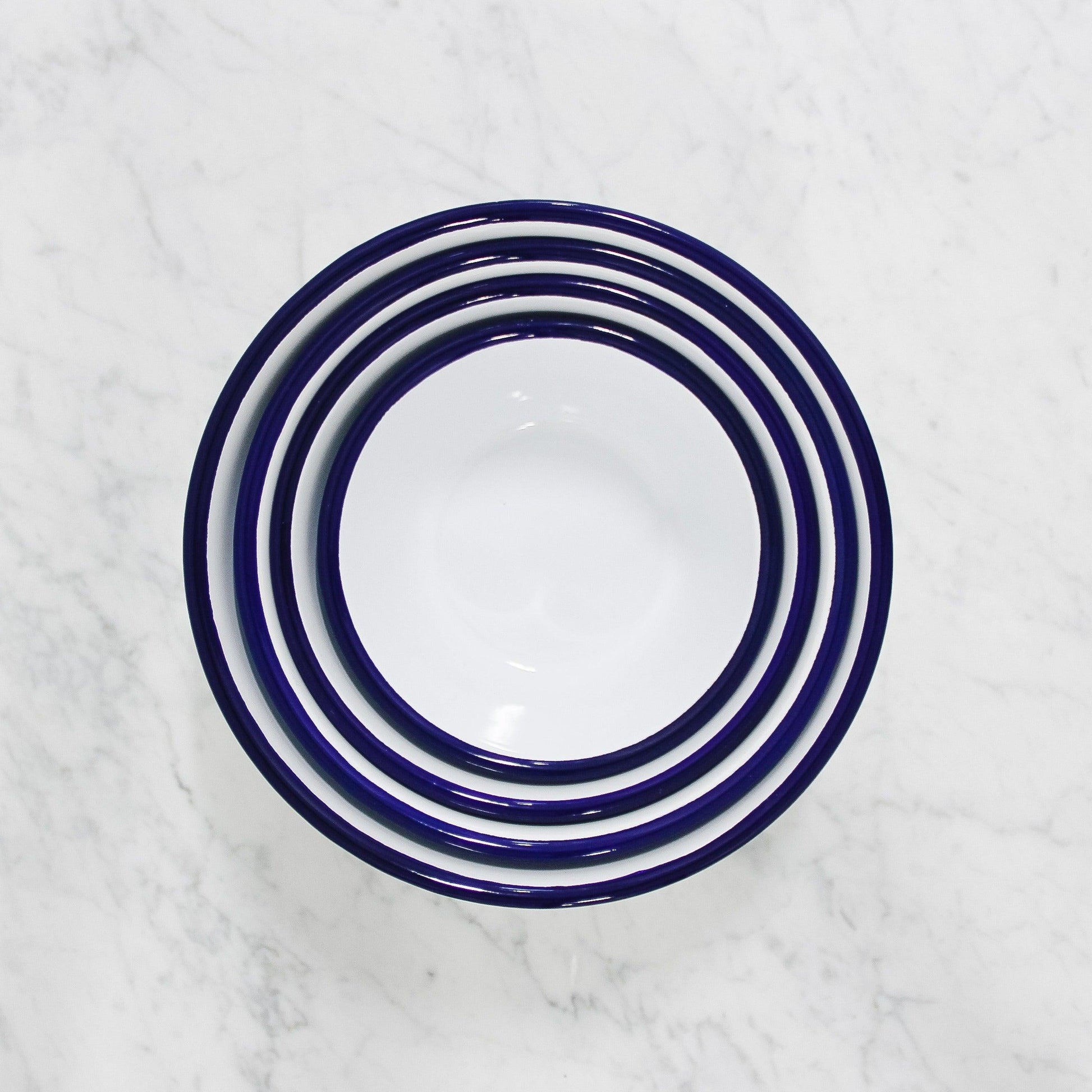 above view of stack of white enamel mixing bowls